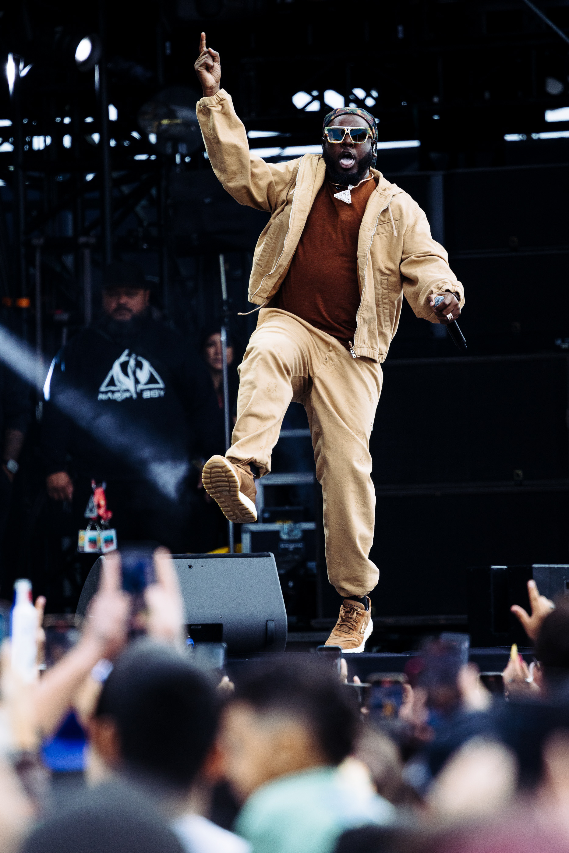 performer in a tan suit dancing on stage at a music festival, San Antonio festival photographer Chris Stokes