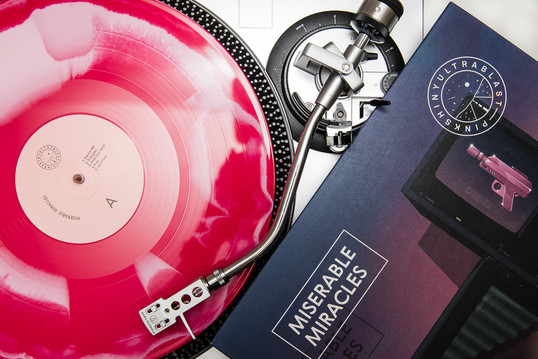red vinyl records with a turntable, vinyl record photography in San Antonio by Chris Stokes