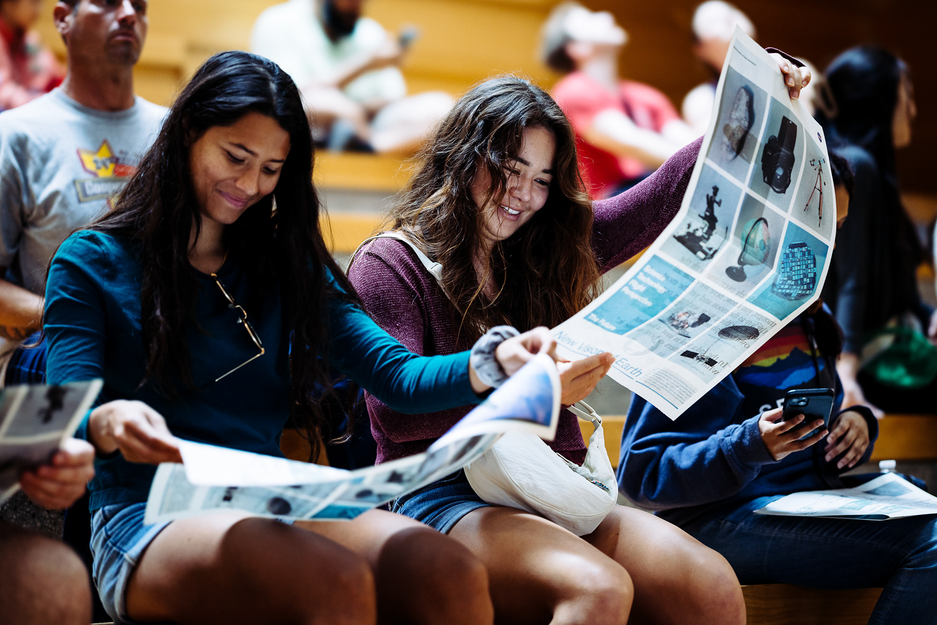 Attendee reading a printed program at an event