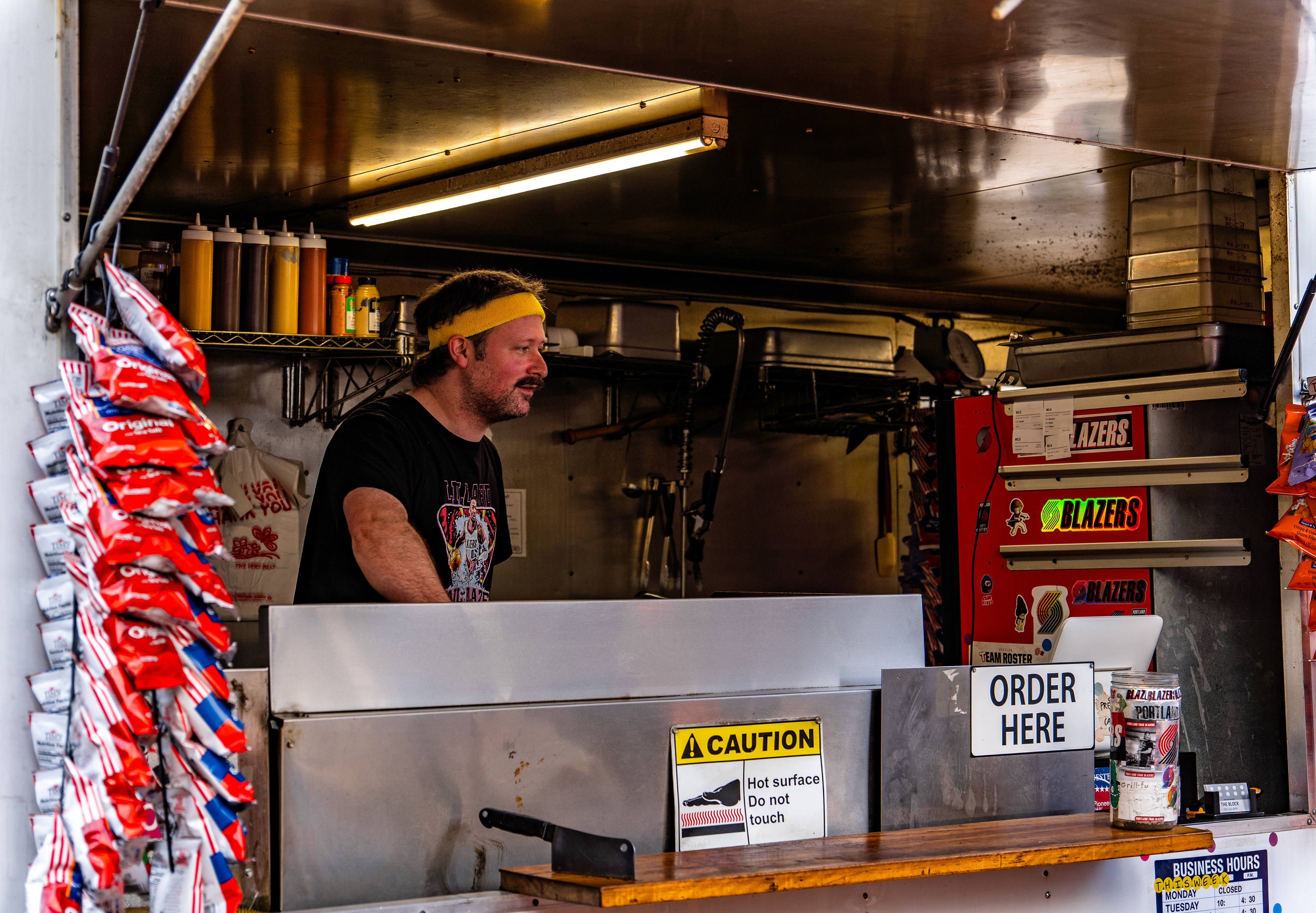 Ben is working at “The Block” food truck in Pioneer Square. He is pictured cooking up some Philly Cheesesteaks while making friendly conversation with hungry customers.