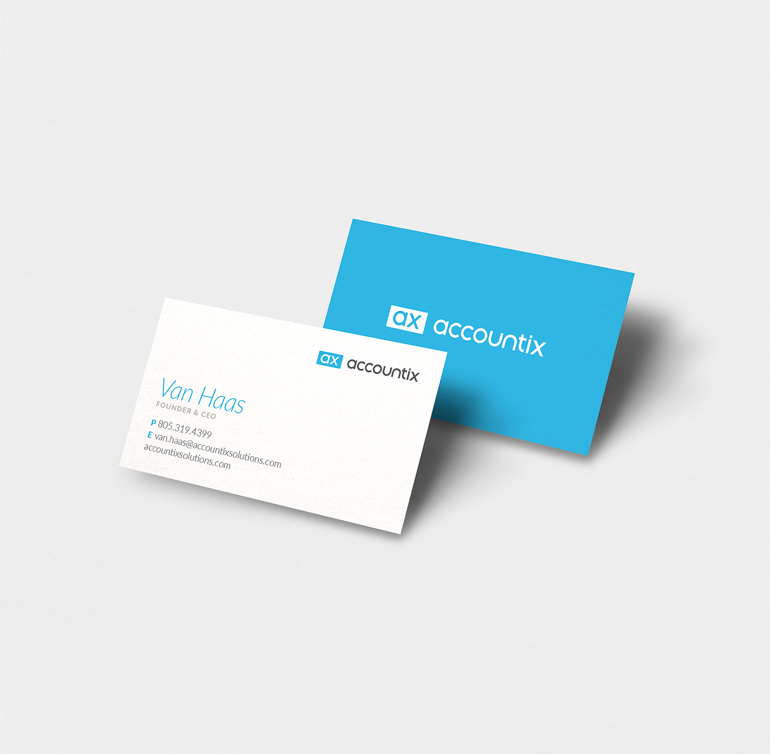 Photo of the front and back of the Founder and CEO's business card featuring the brand's signature bright blue color (designs by Kat Vochoska).
