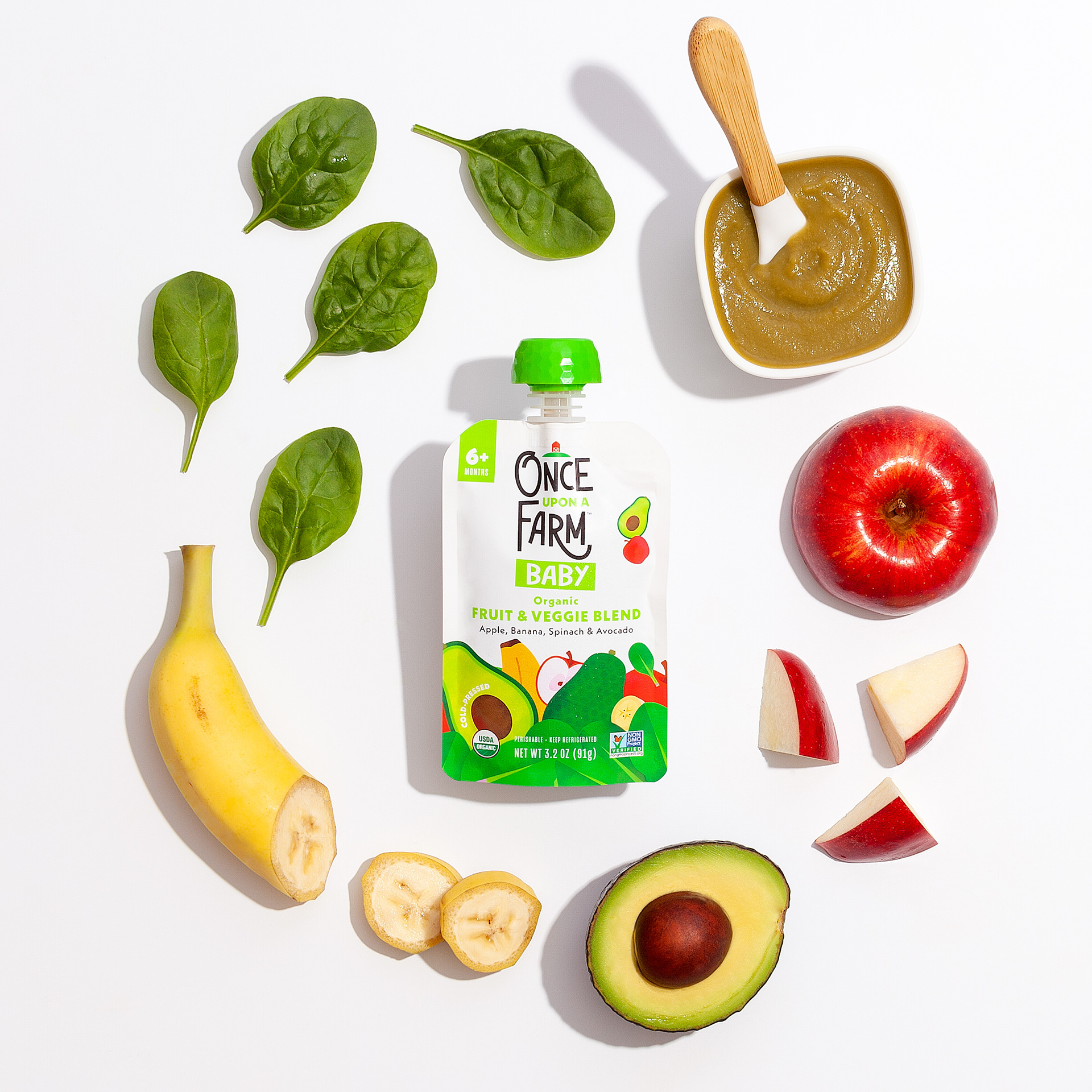 Baby food product surrounded by fruit and vegetable ingredients (photo by Katie Wann).