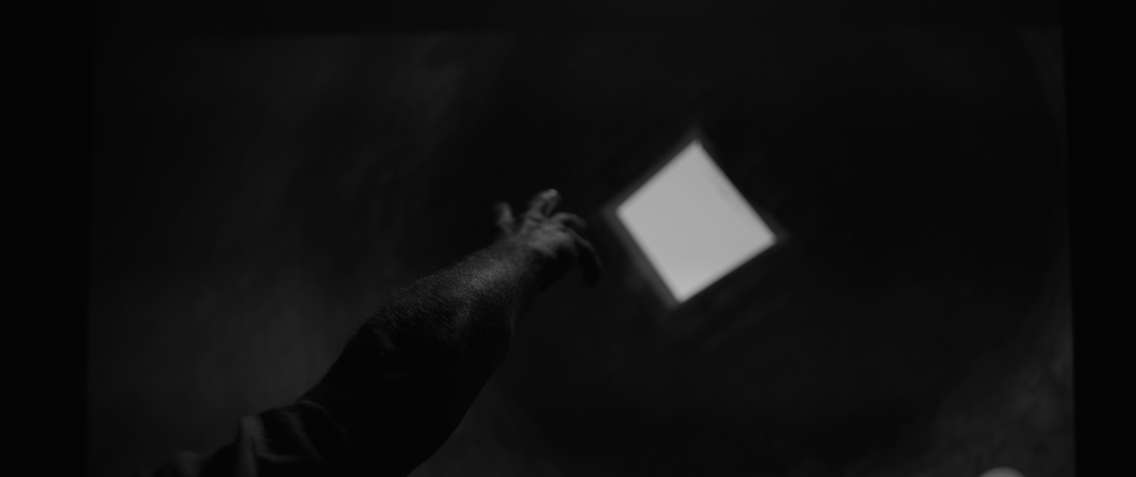 Old Man reaches towards the hole.