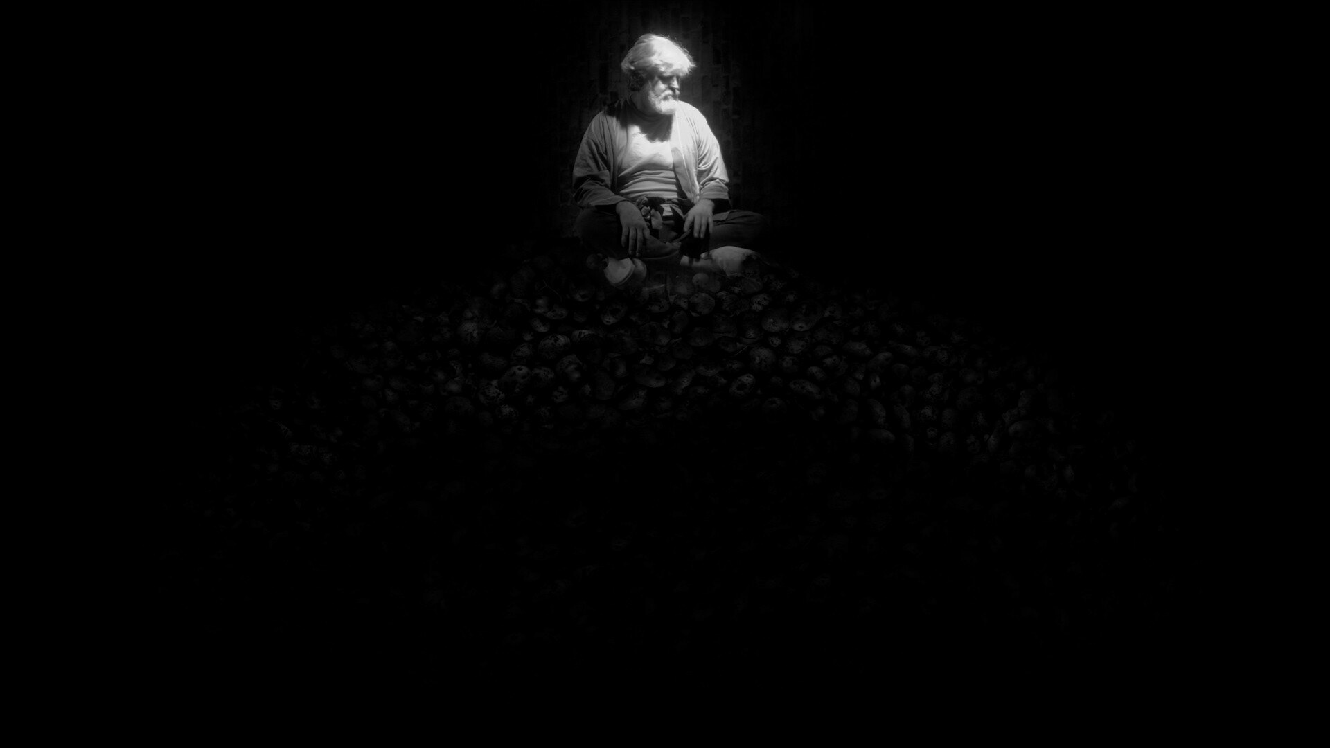 Old Man sitting like a king on his throne of potatos.