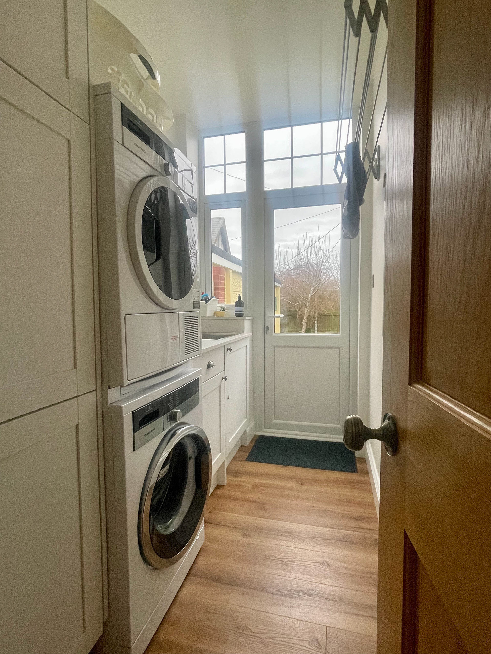 A practical laundry room with washing machine & tumble dryer