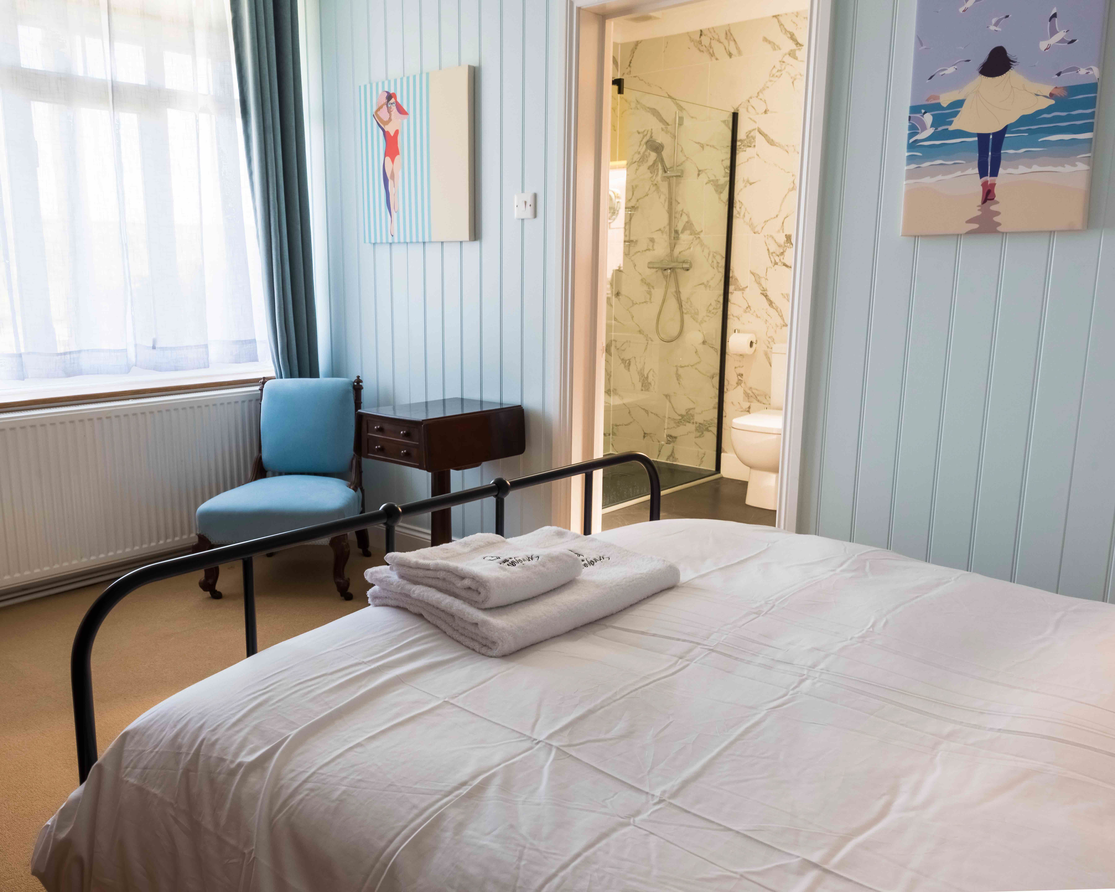 Blue-hued ensuite room on the ground floor floor — restful and bright
