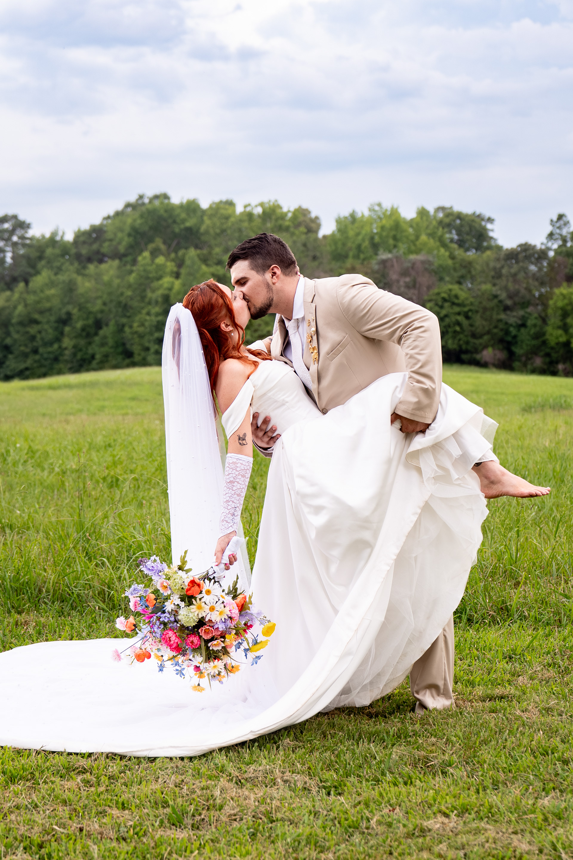 Couple kissing in middle of a field