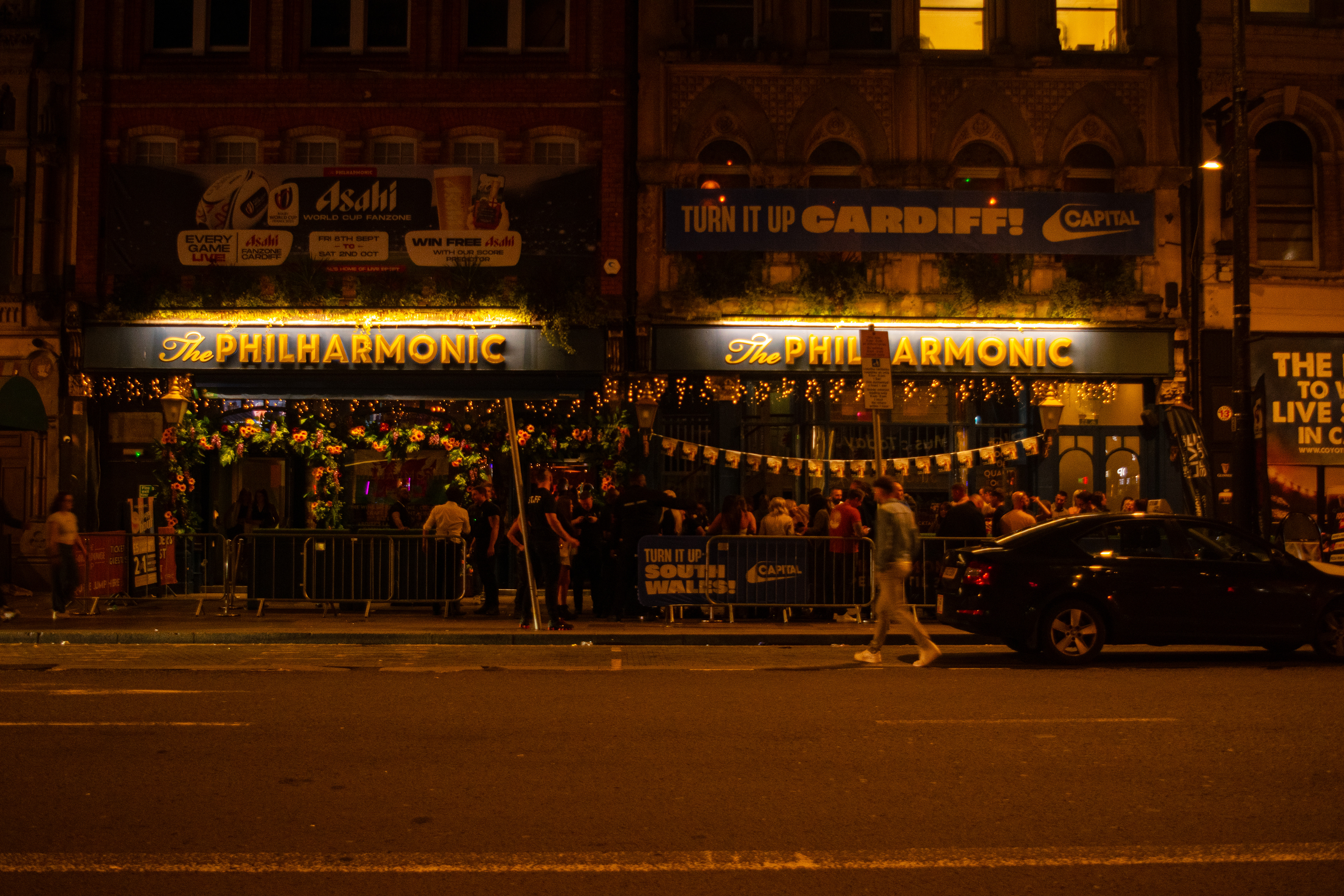 A man walks towards the entrance to the pub.