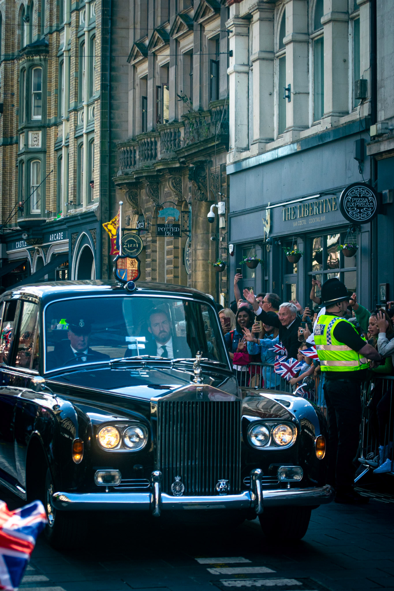 The King makes his way on the 1978 Rolls Royce Phantom VI through the narrow but lively St Mary Street. This state limousine has been with the royal family for over 40 years.