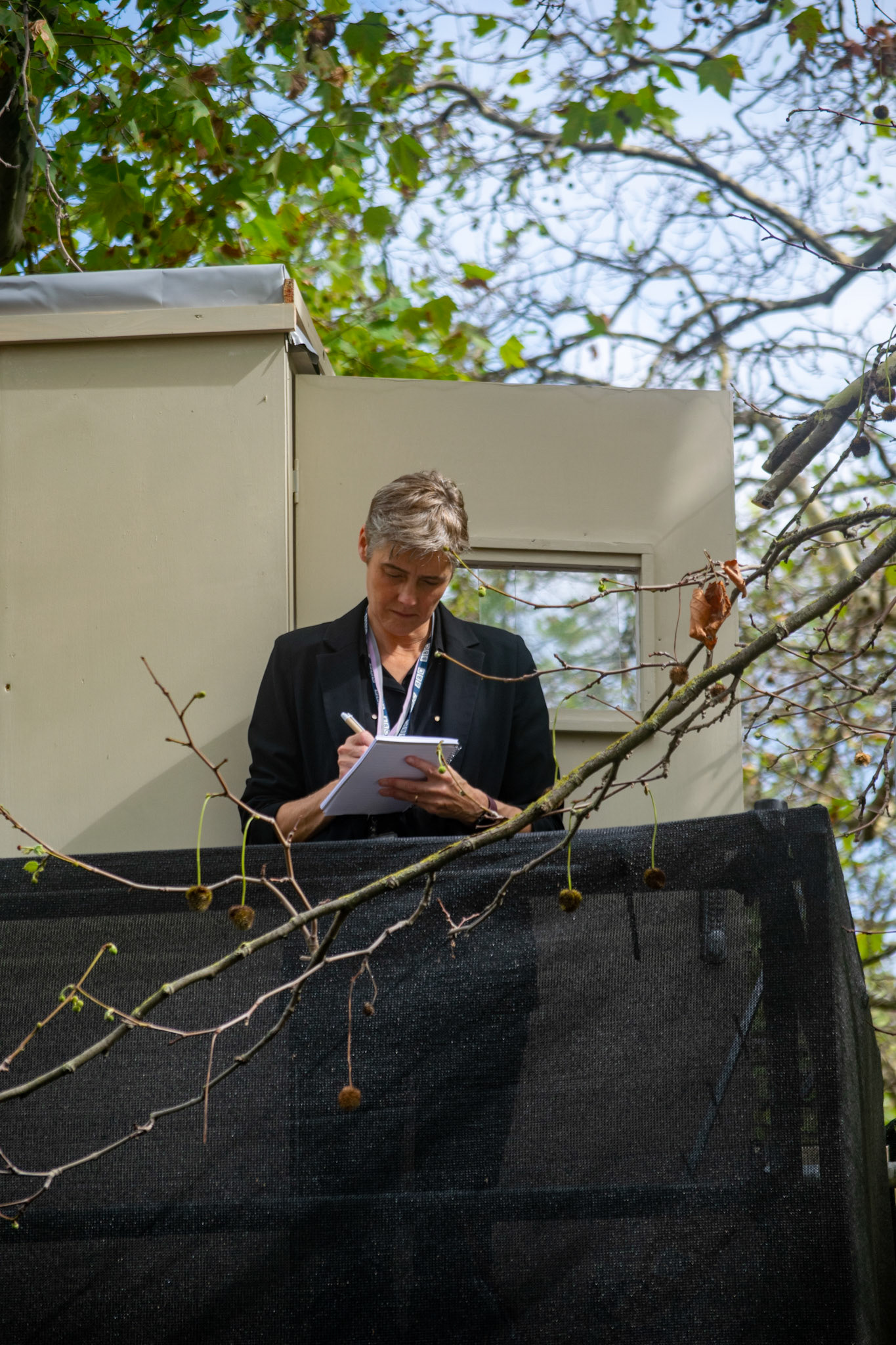 A BBC Journalist takes notes of the royal procession; minute details are necessary for the perfect coverage.