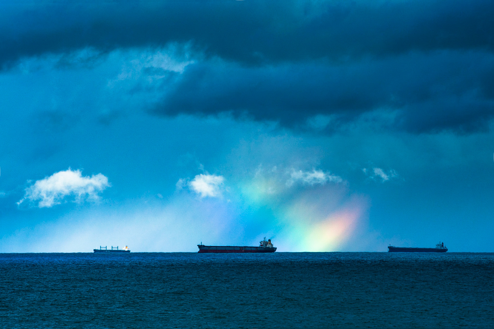 Gold at the end of the rainbow- ships awaiting entry to the Port of Newcastle