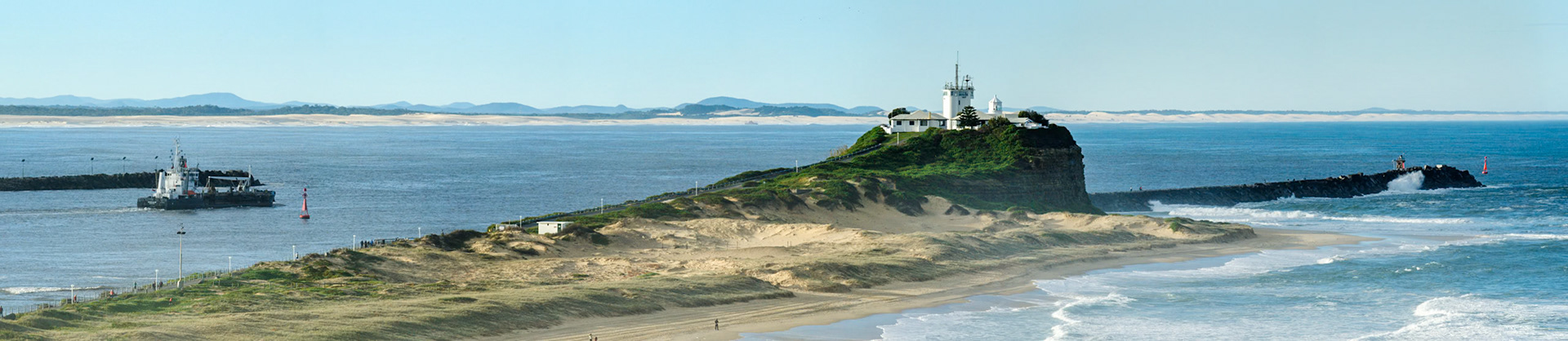 Panorama showing Nobbys headland and Nobby's beach.