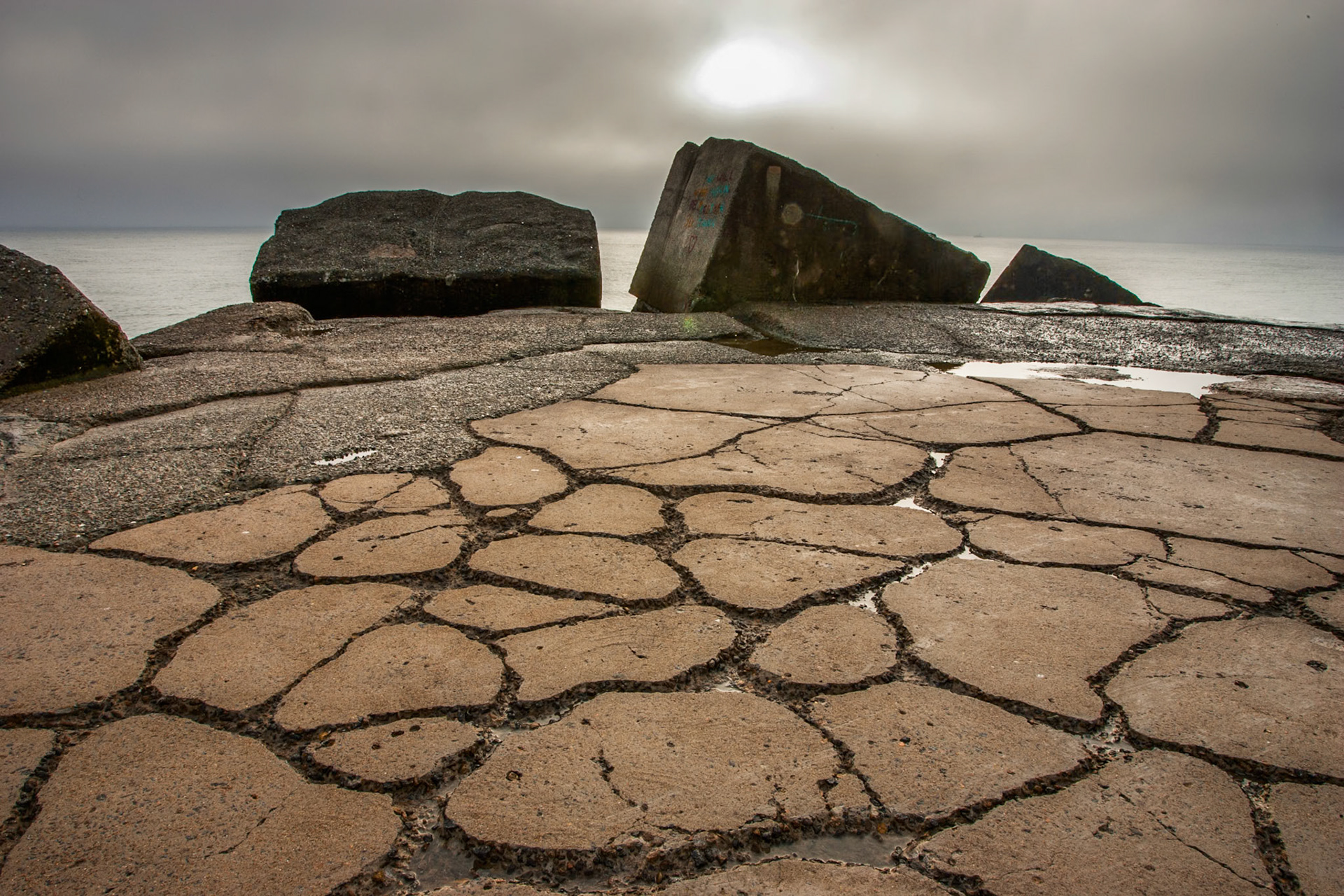 An early, very misty drizzly morning on Macquaries pier at the end of Nobby's headland in Newcastle, New South Wales, Australia. The sun couldn't pierce the clouds making for a very sureal, stark landscape.