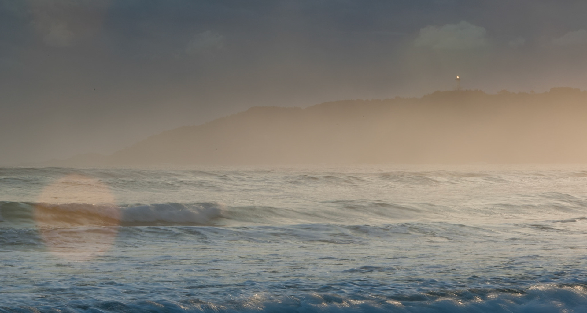 Surf and Byron Bay lighthouse, Belongil Beach, Byron Bay, New South Wales