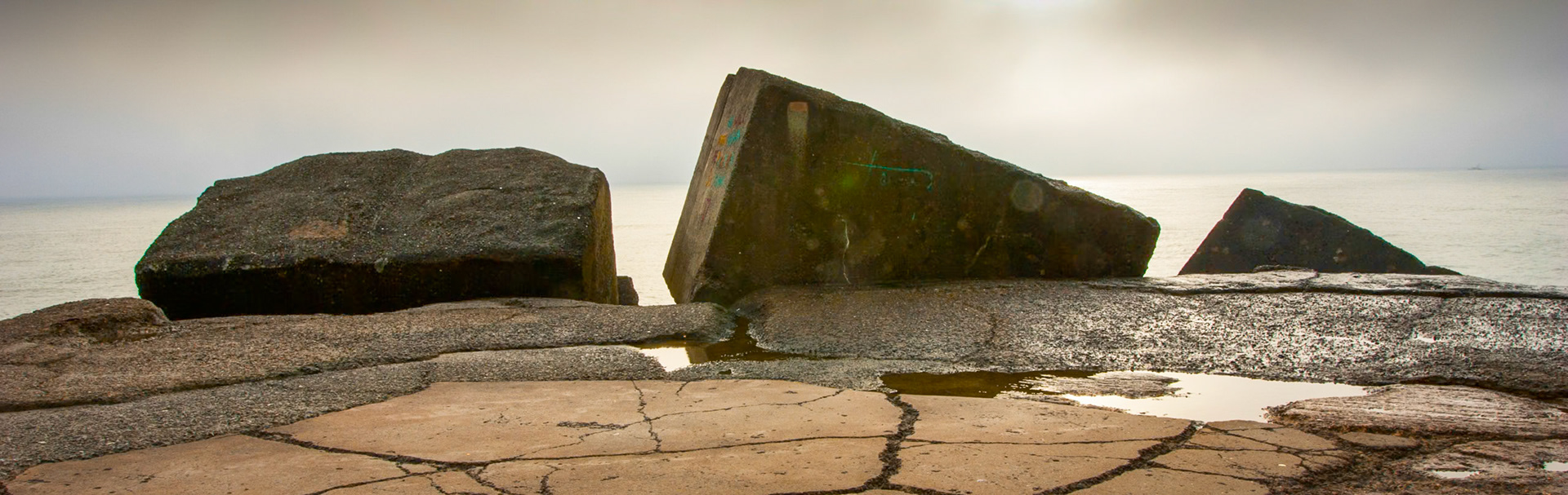 An early, very misty drizzly morning on Macquaries pier at the end of Nobby's headland in Newcastle, New South Wales, Australia. The sun couldn't pierce the clouds making for a very sureal, stark landscape.