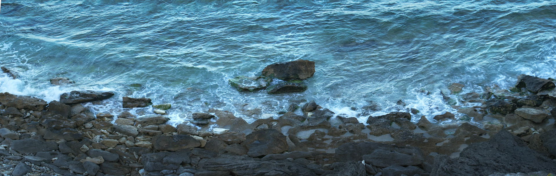 Panoramic view of the rocks and the sea at Middle Beach, Lord Howe Island.