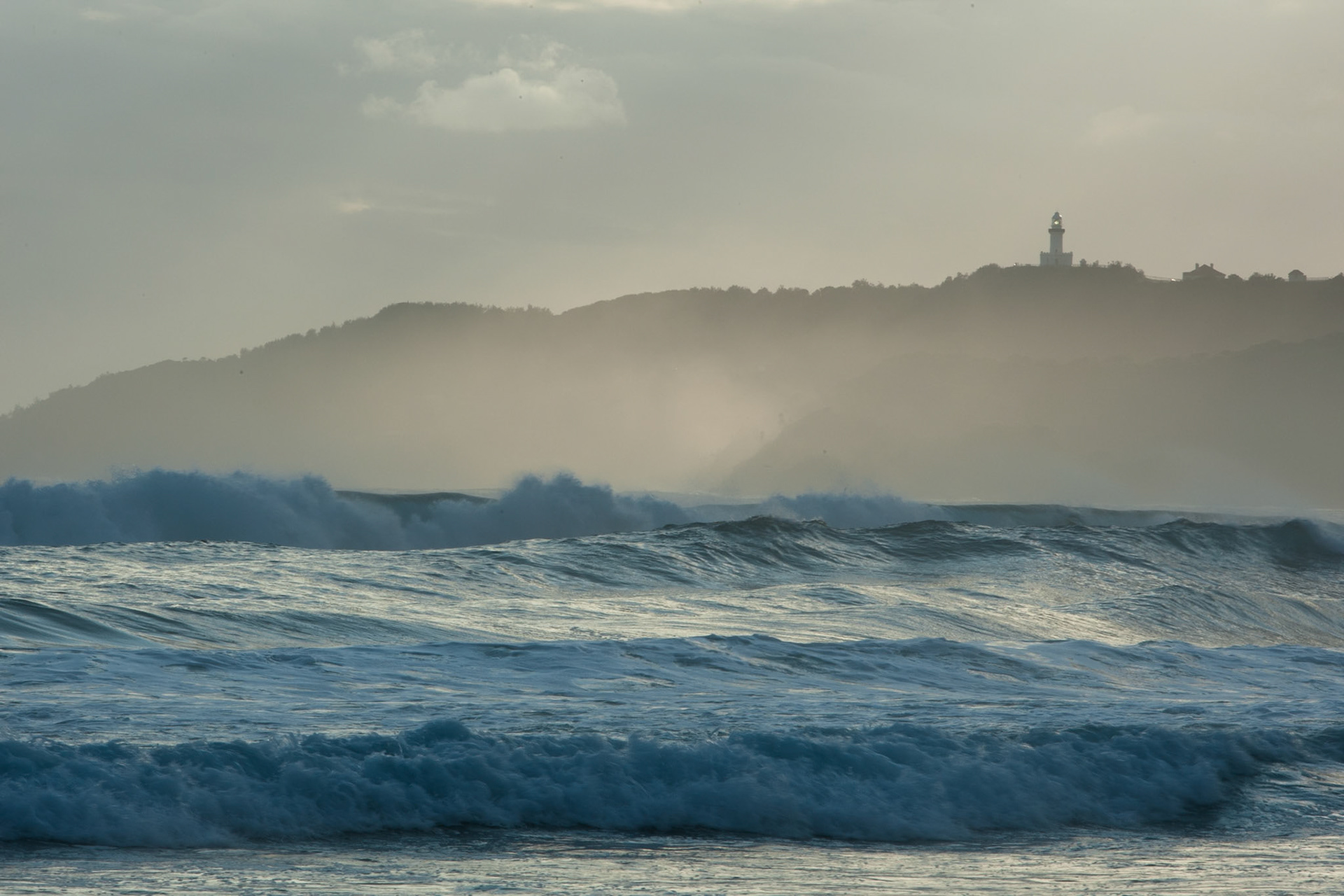 Surf and Byron Bay lighthouse, Belongil Beach, Byron Bay, New South Wales