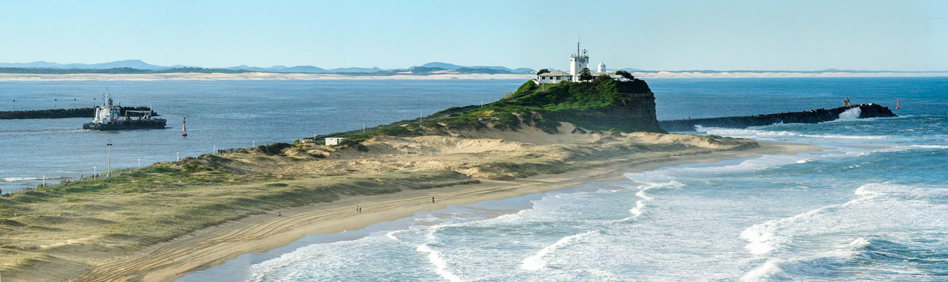 Panorama showing Nobbys headland and Nobby's beach.