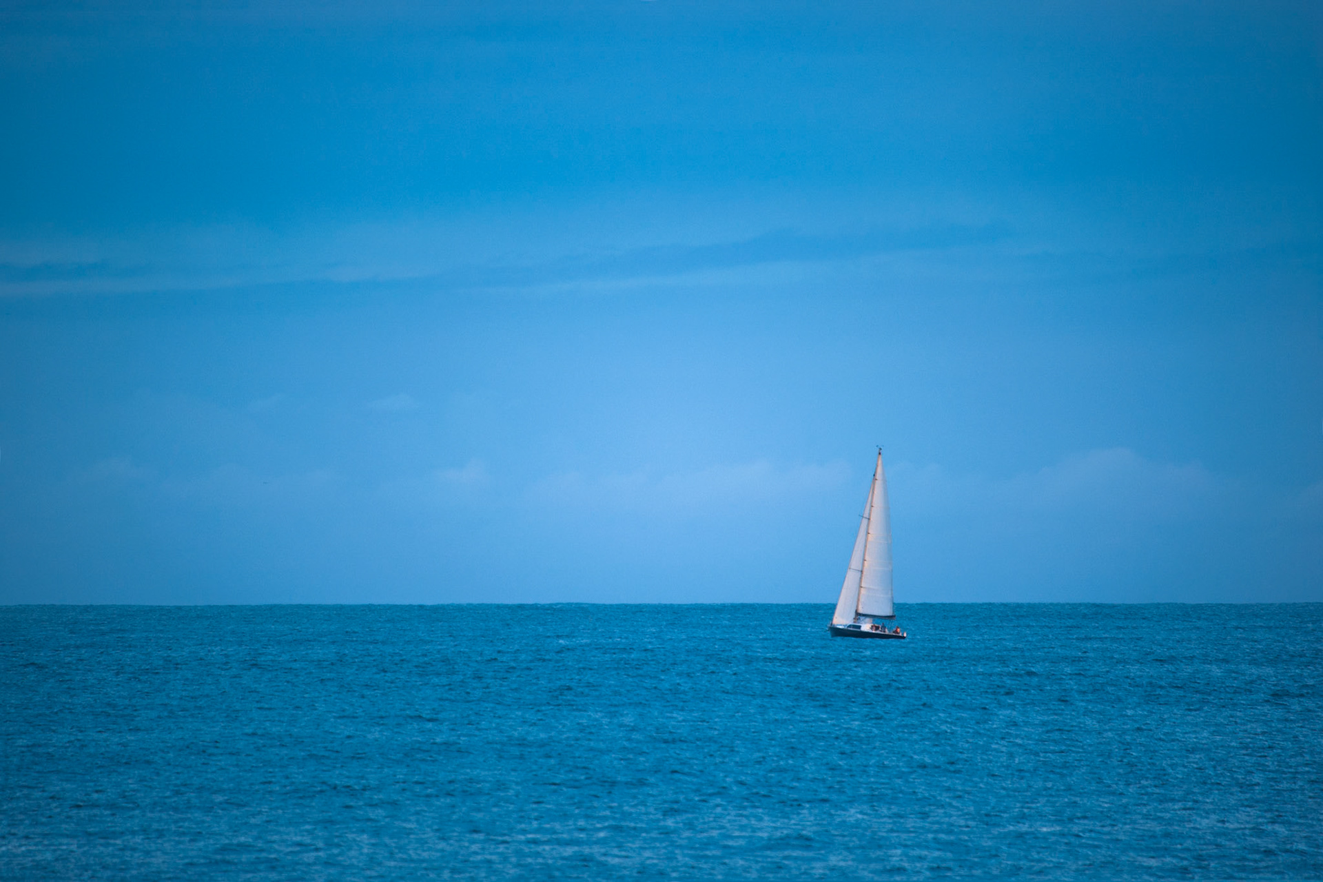 Late afternoon sun, caught the sails of this lone yacht, Stockton