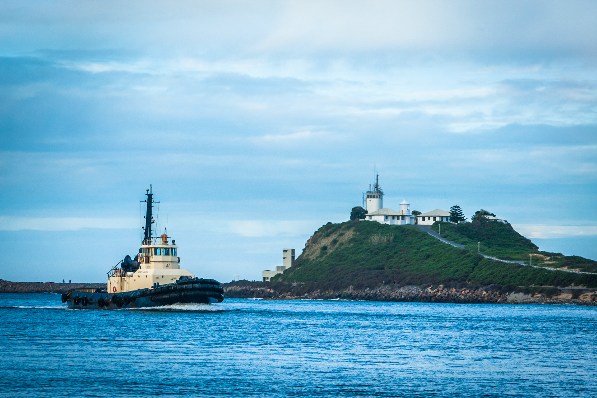 Three tugs guided New Stage, a bulk carrier, down the Hudson river to the open sea. Newcastle.