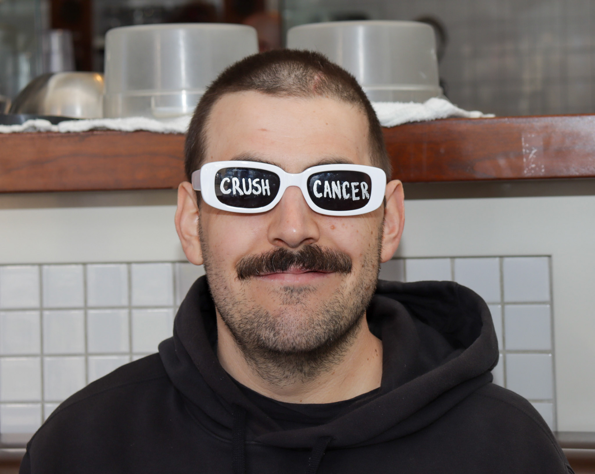 Geoff Boc at rocking his "crush cancer" sunglasses from their previous fundraiser event. April 18, 2024 in Calgary, Alberta. Photo by Jenna Willox