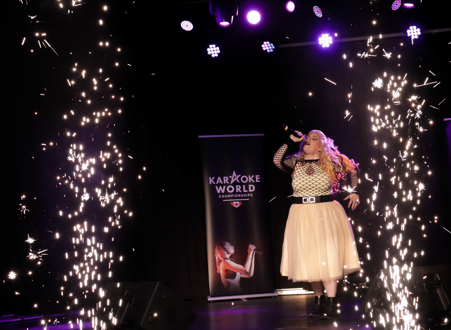Karaoke World Championship host Erin Marchetto Meyer at the 2023 provincial qualifiers in Calgary singing her opening number.(Photo by Jenna Willox)