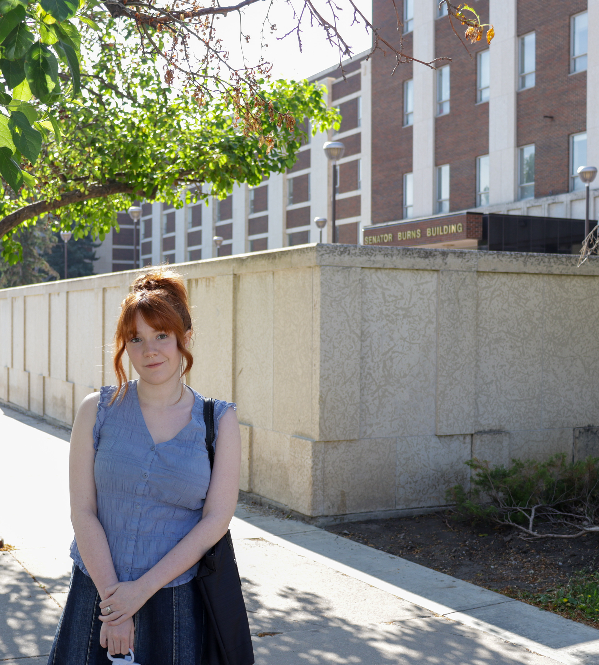 SAIT photojournalism student Rhiannon Smith in front of the Senator Burns building on the SAIT campus. (Photo by Jenna Willox)