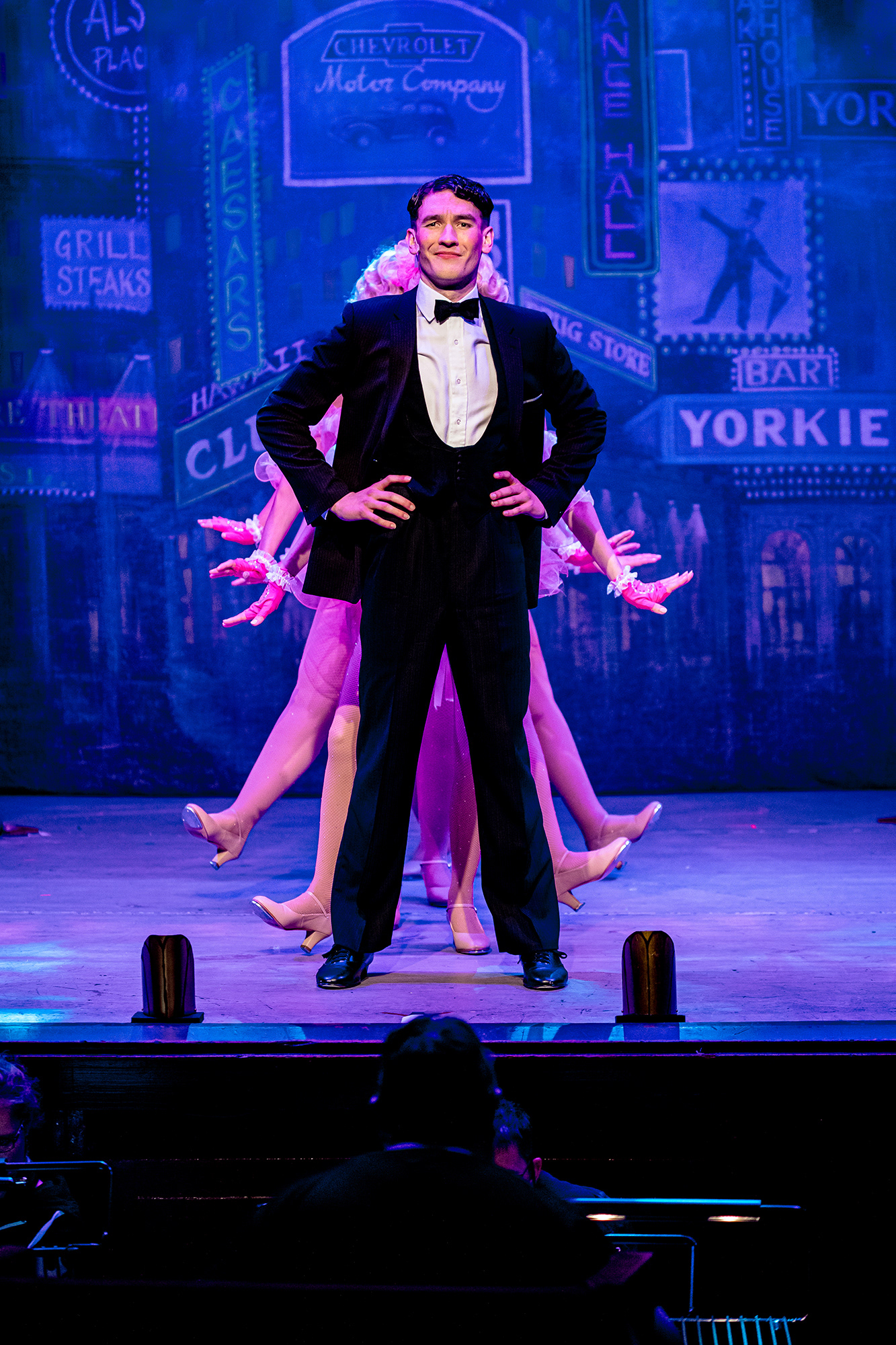 Bobby Child standing proud with the Follies dancing behind - Witham Amateur Operatic Society's "Crazy For You".