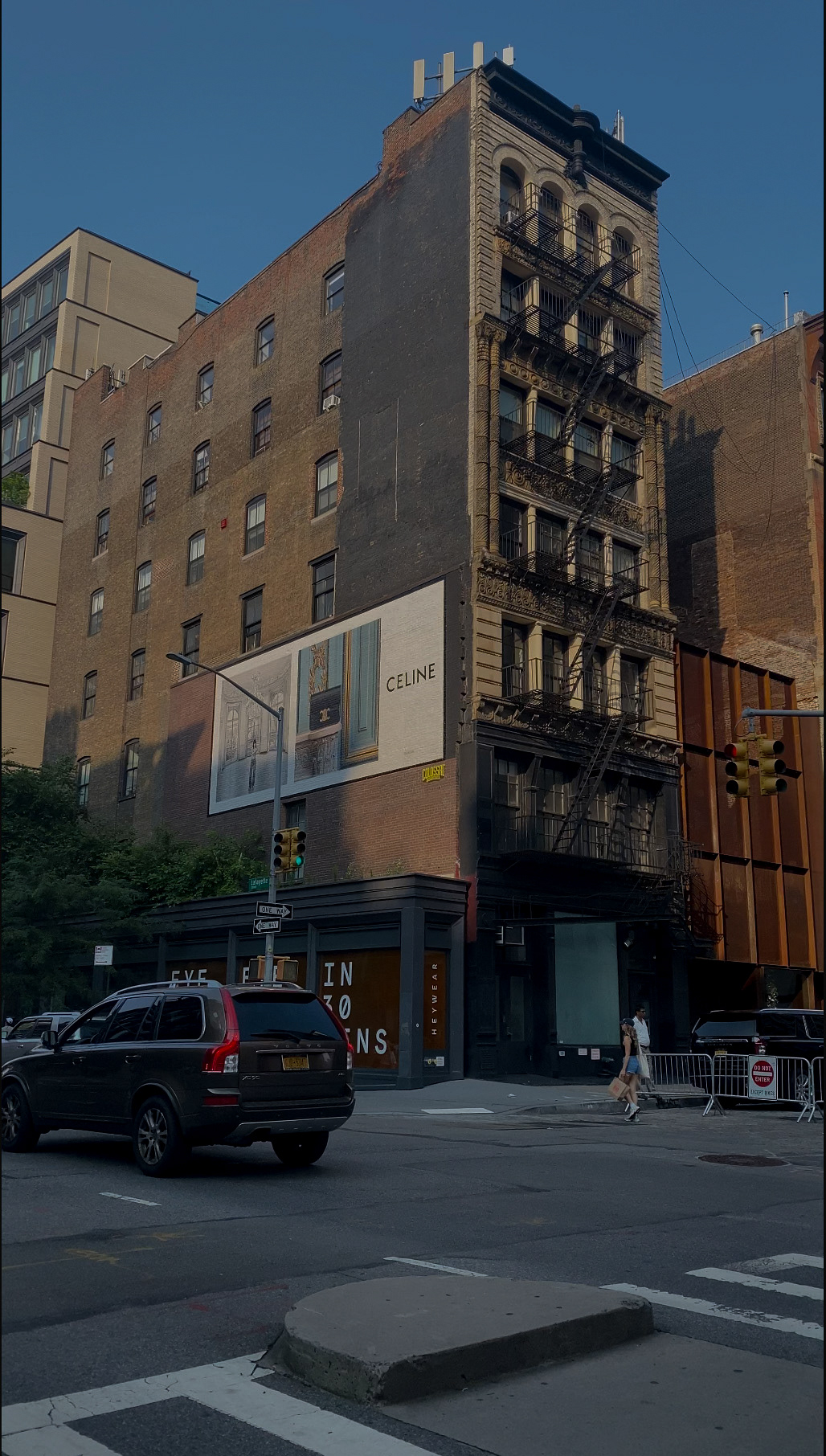 An NYC photograph reveals the streets of the Soho area with a mini billboard of the high luxury fashion brand Celine for their accessory line collection.