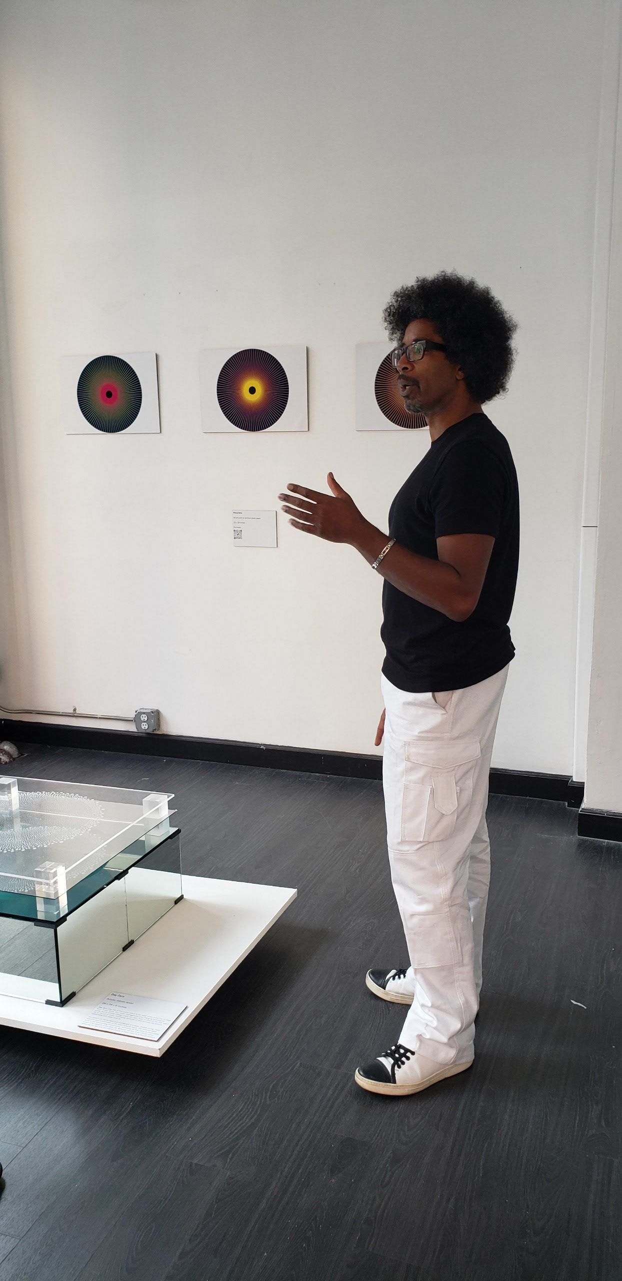 Jason Robinson discusses pieces at his solo art and design show.