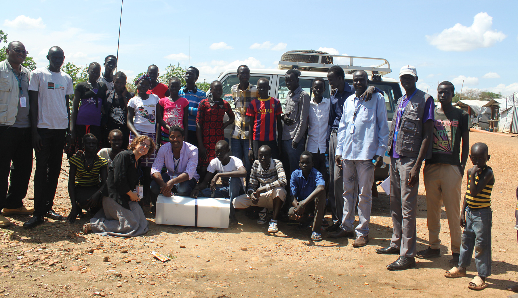 Designer Jason Robinson poses with UNICEF staff and Adolescent Kit in Juba, South Sudan.