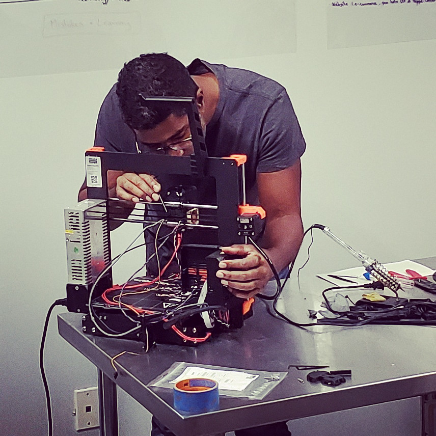 Jason repairing his 3D printer.