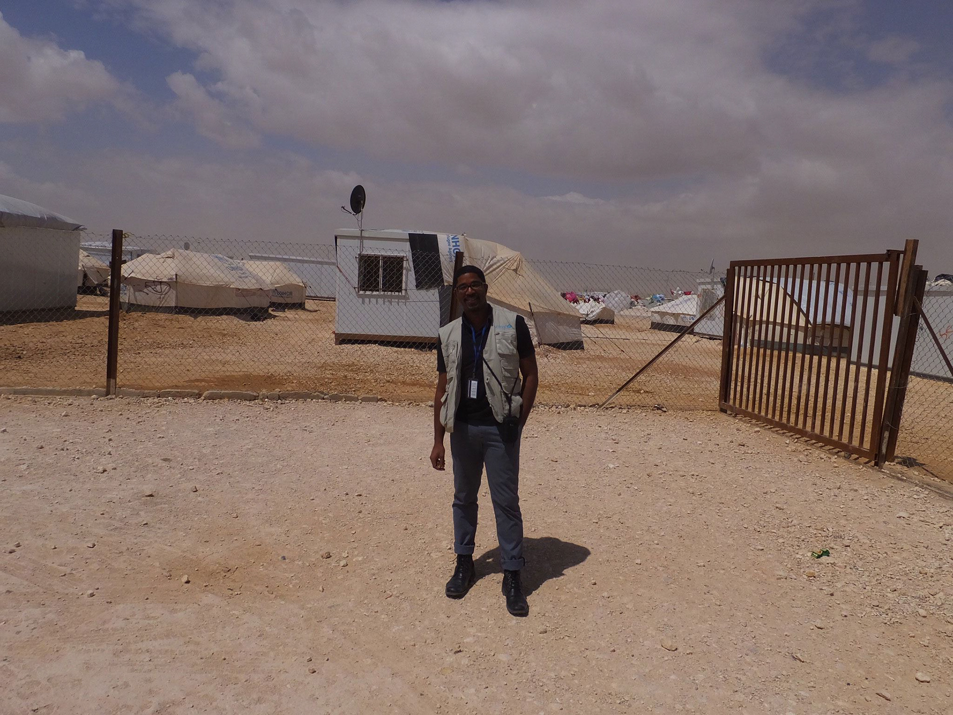 Designer Jason Robinson standing in Zaatari refugee camp.