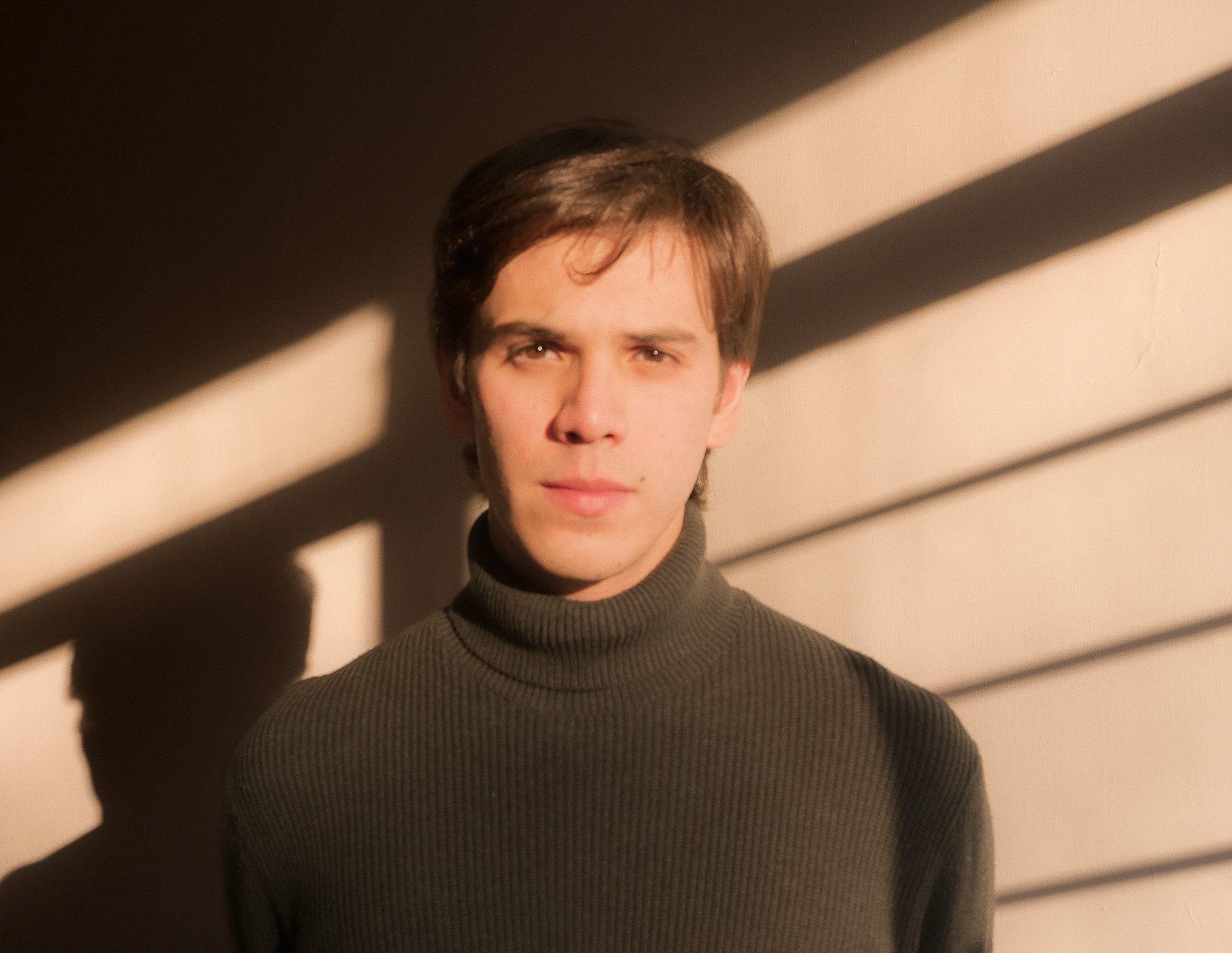 Portrait of Andres Estrada by the window.