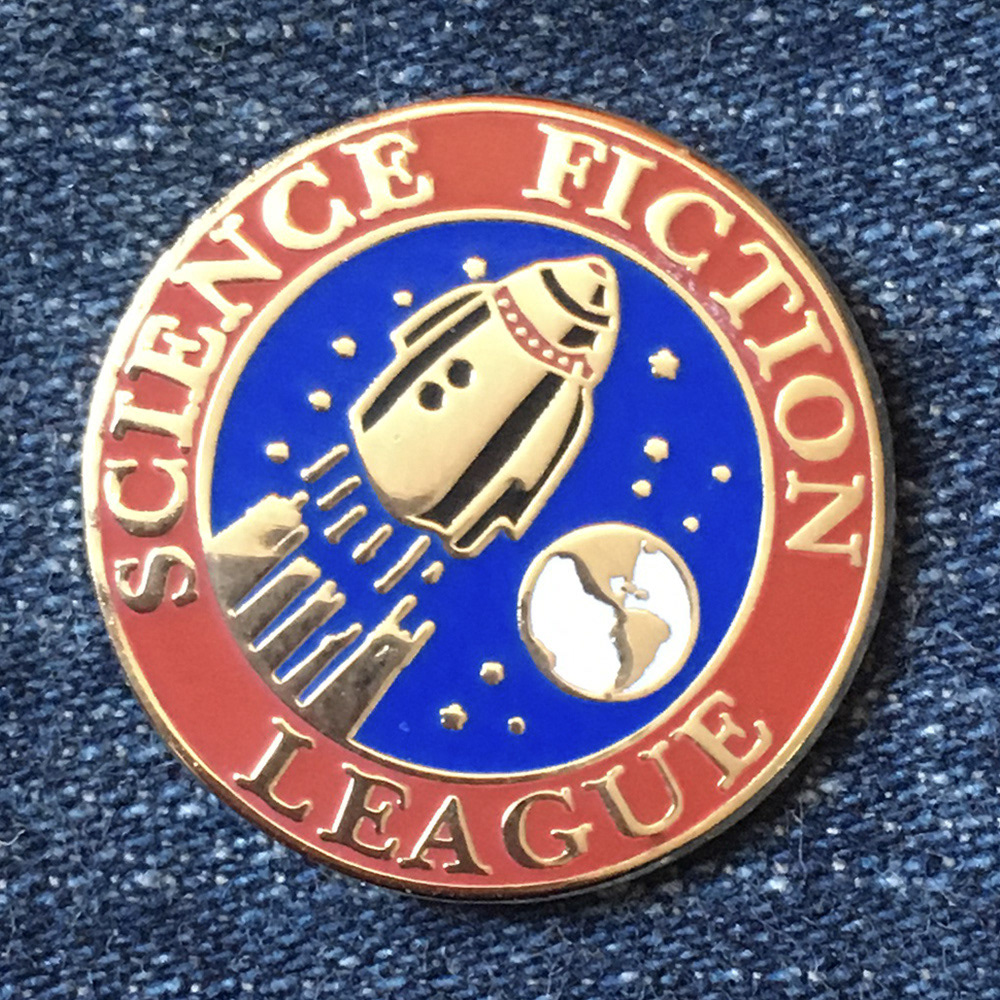 I redesigned Frank R Paul's Science Fiction League pin to suit modern enamel pins