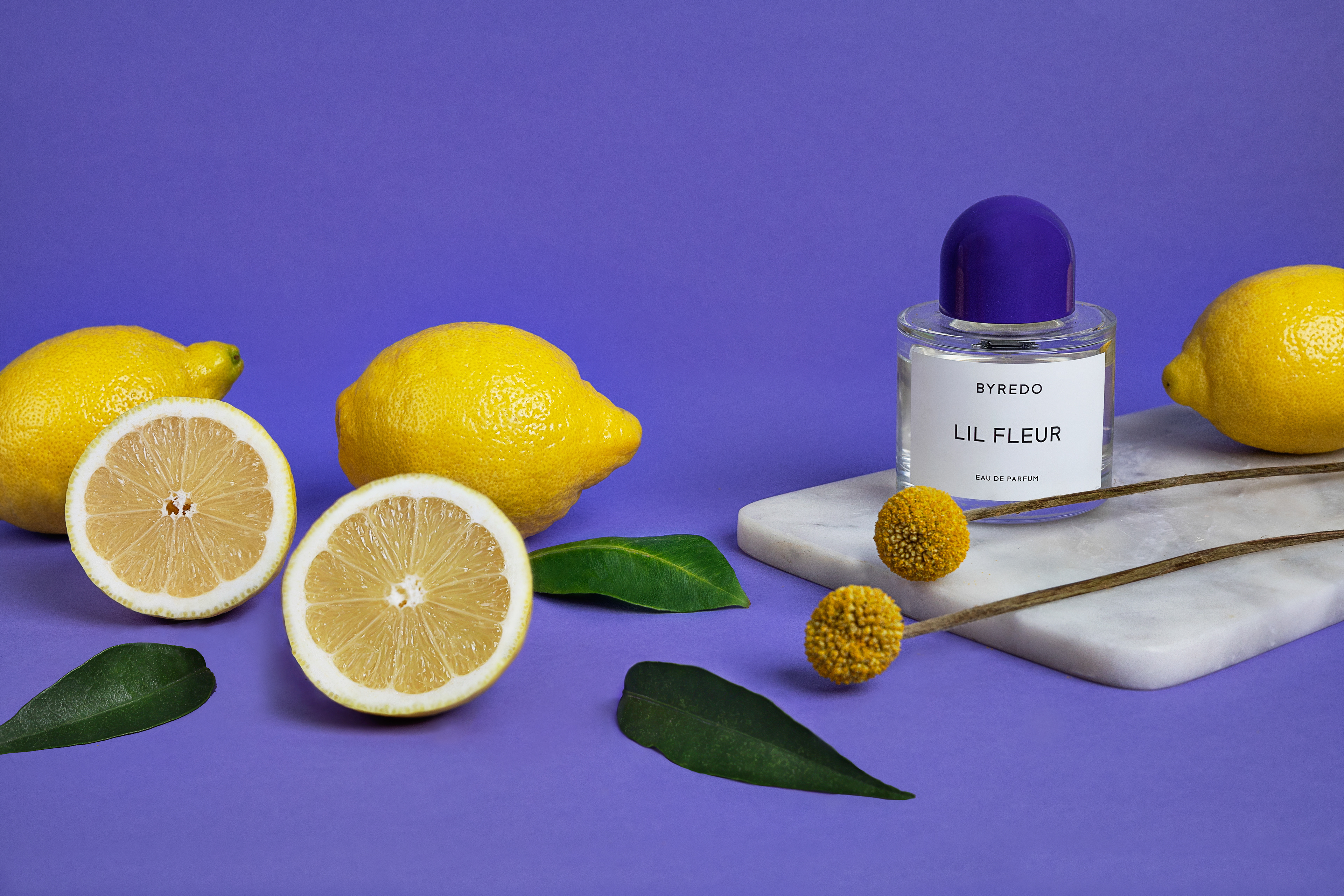 still life photographer based in Barcelona. Still life of Byredo perfume with lemons and purple background