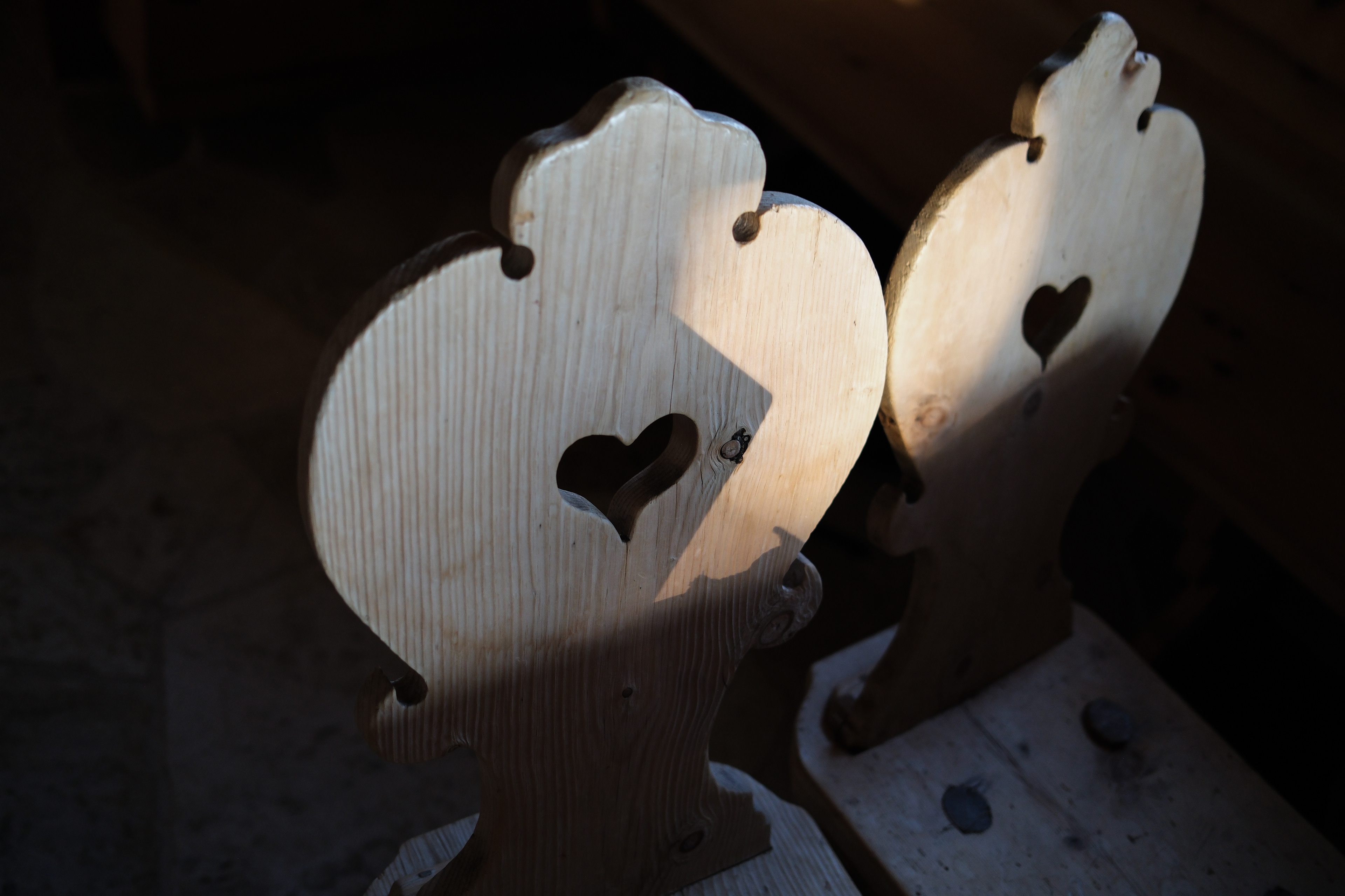 typical wooden Alps chairs with heart, shadows