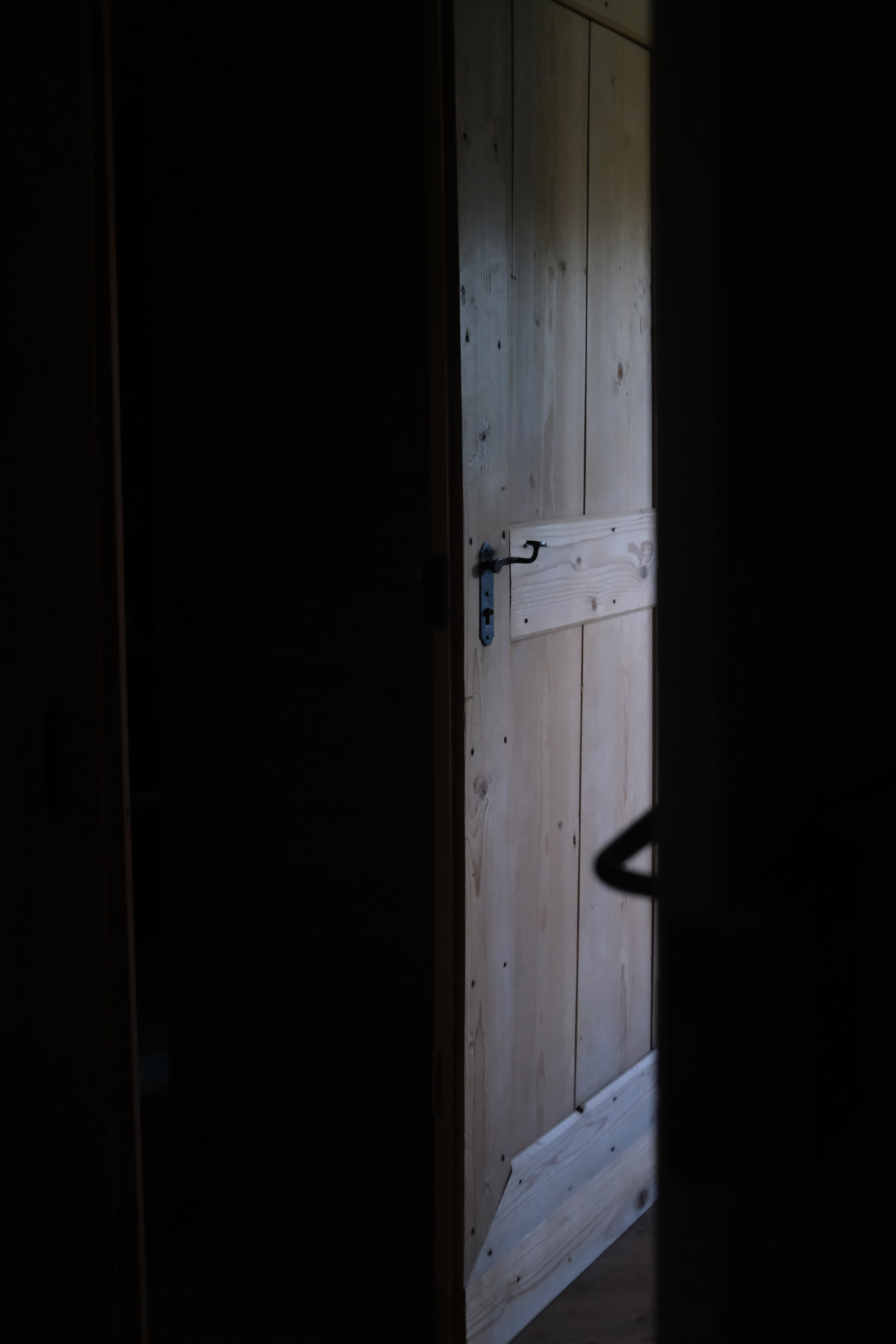 wooden hut from the inside, wooden door in the hut from Zirmerhof hotel