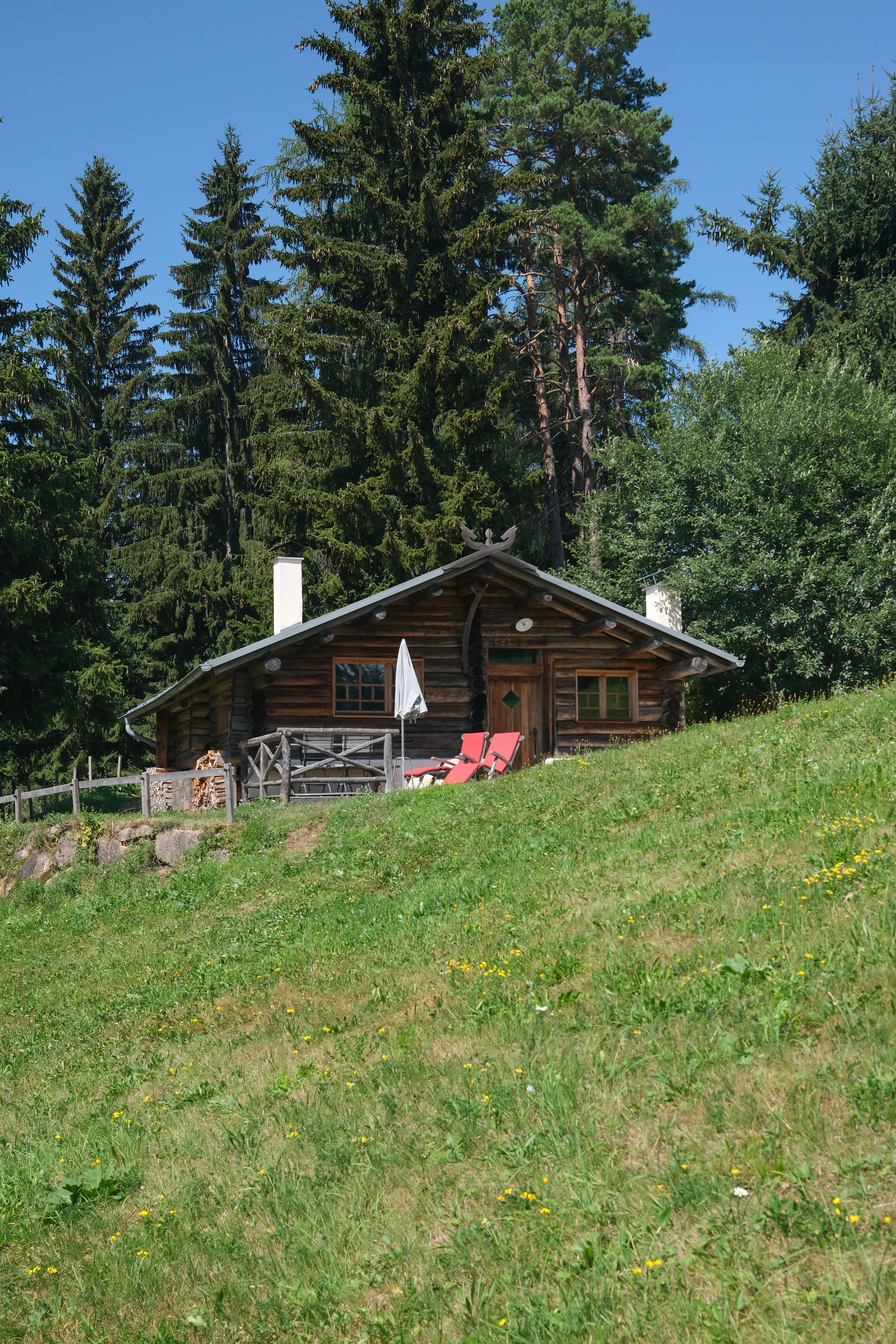 wooden hut in the grass of Sudtirol, part of the zirmerhof hotel