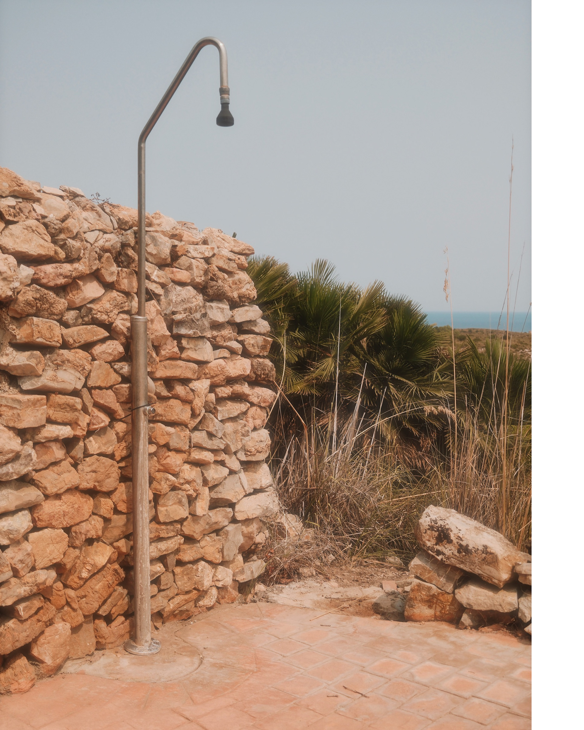 mallorca photography, shower in the mediterranean environment with stones and palms