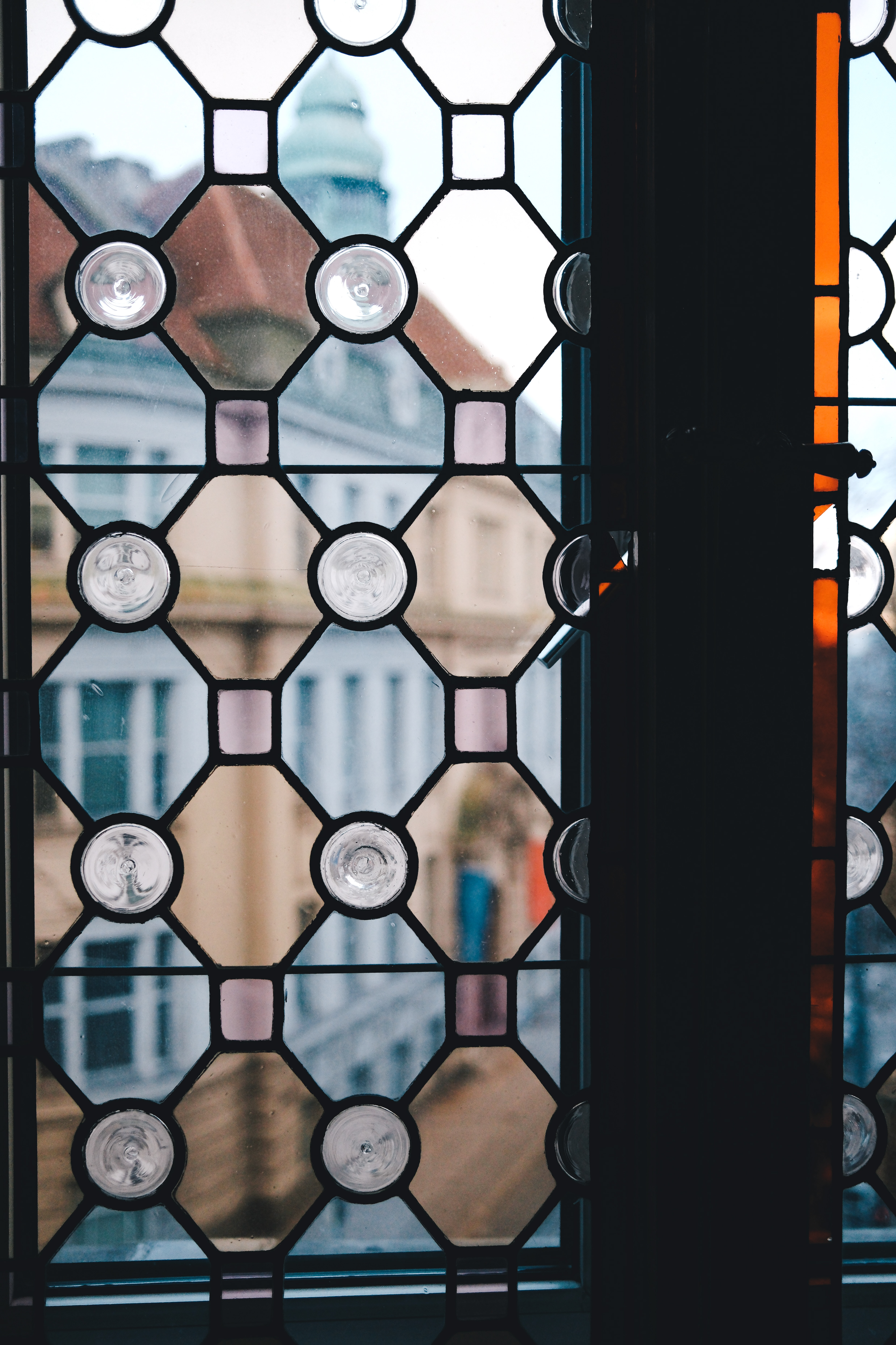 colorful glas window in Viena where you can see through old houses