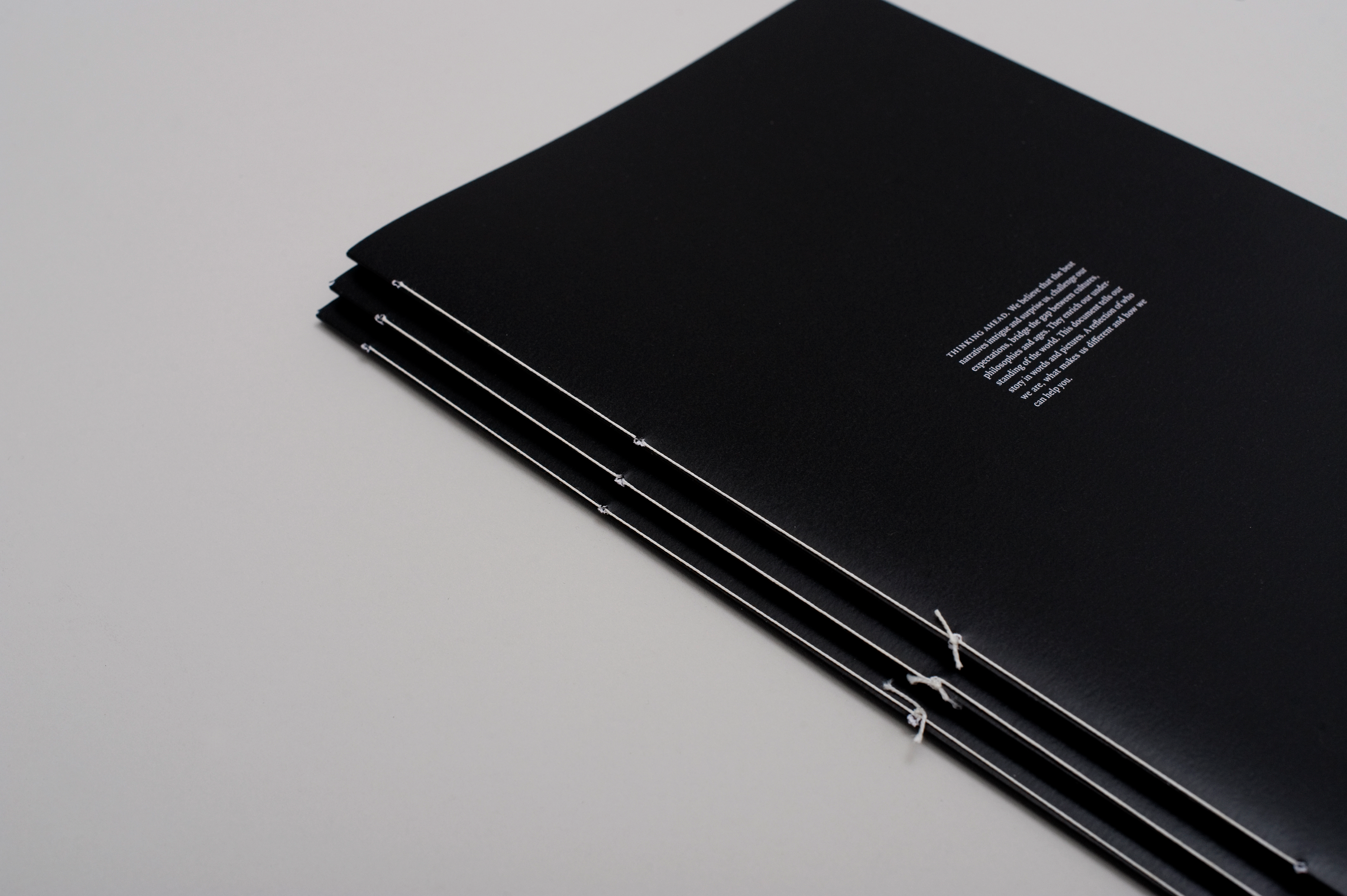 Thread bound cover design for a legal firm brochure.
