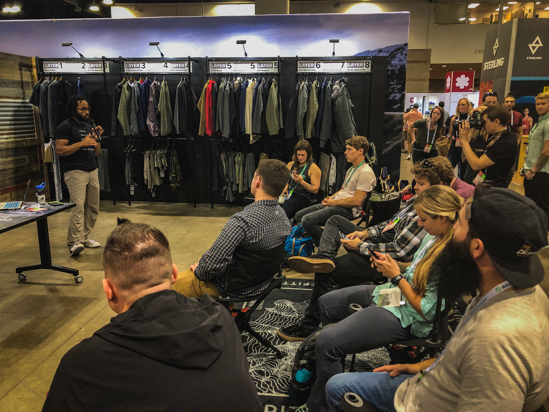 Central space of the booth easily converts into a speaking space with the clothing and layering information on display.