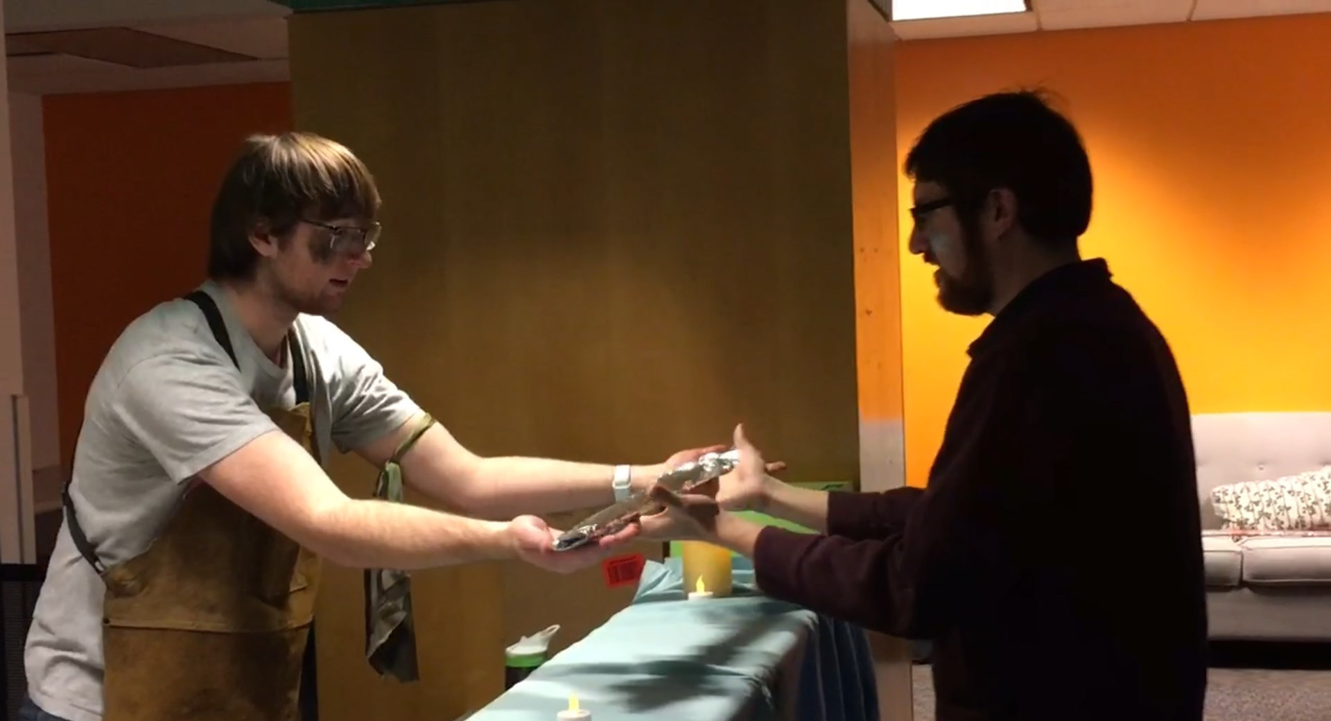 The Forgemaster handing a weapon to a player