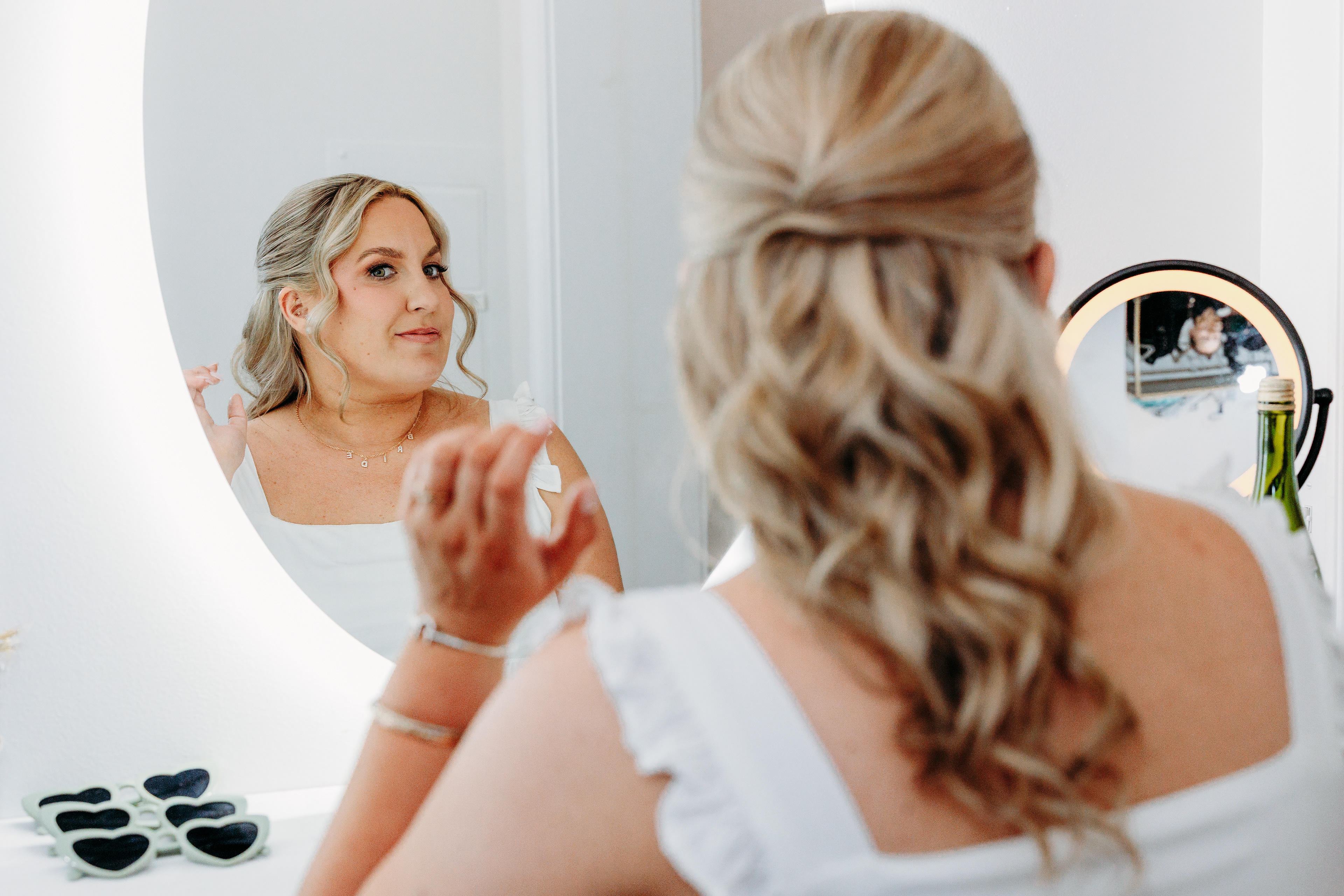 A quiet moment of grace before vows — the bride’s reflection and early mountain light at Indian Head Resort.