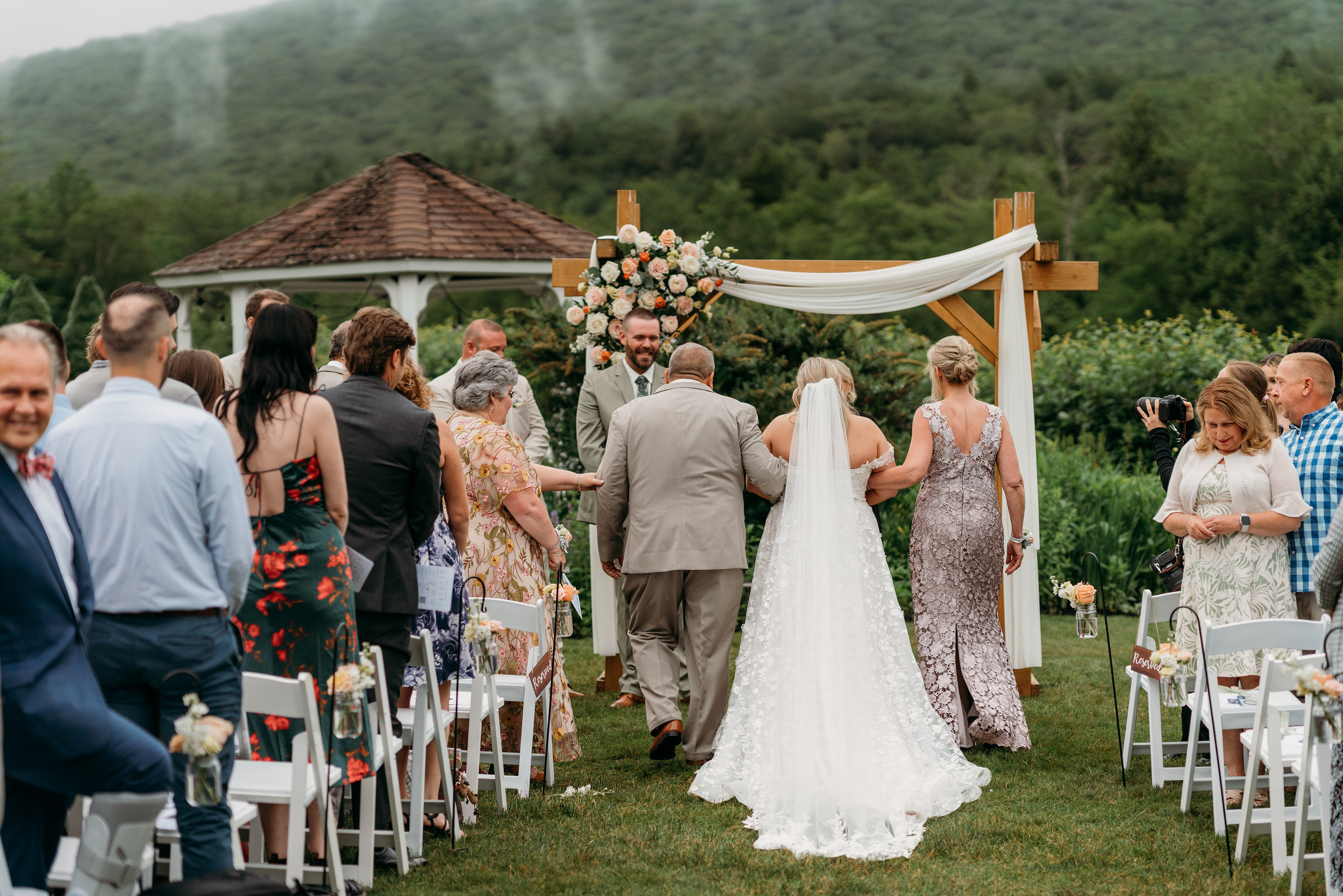 As the fog lifted, so did hearts — the bride’s entrance framed by New England beauty.