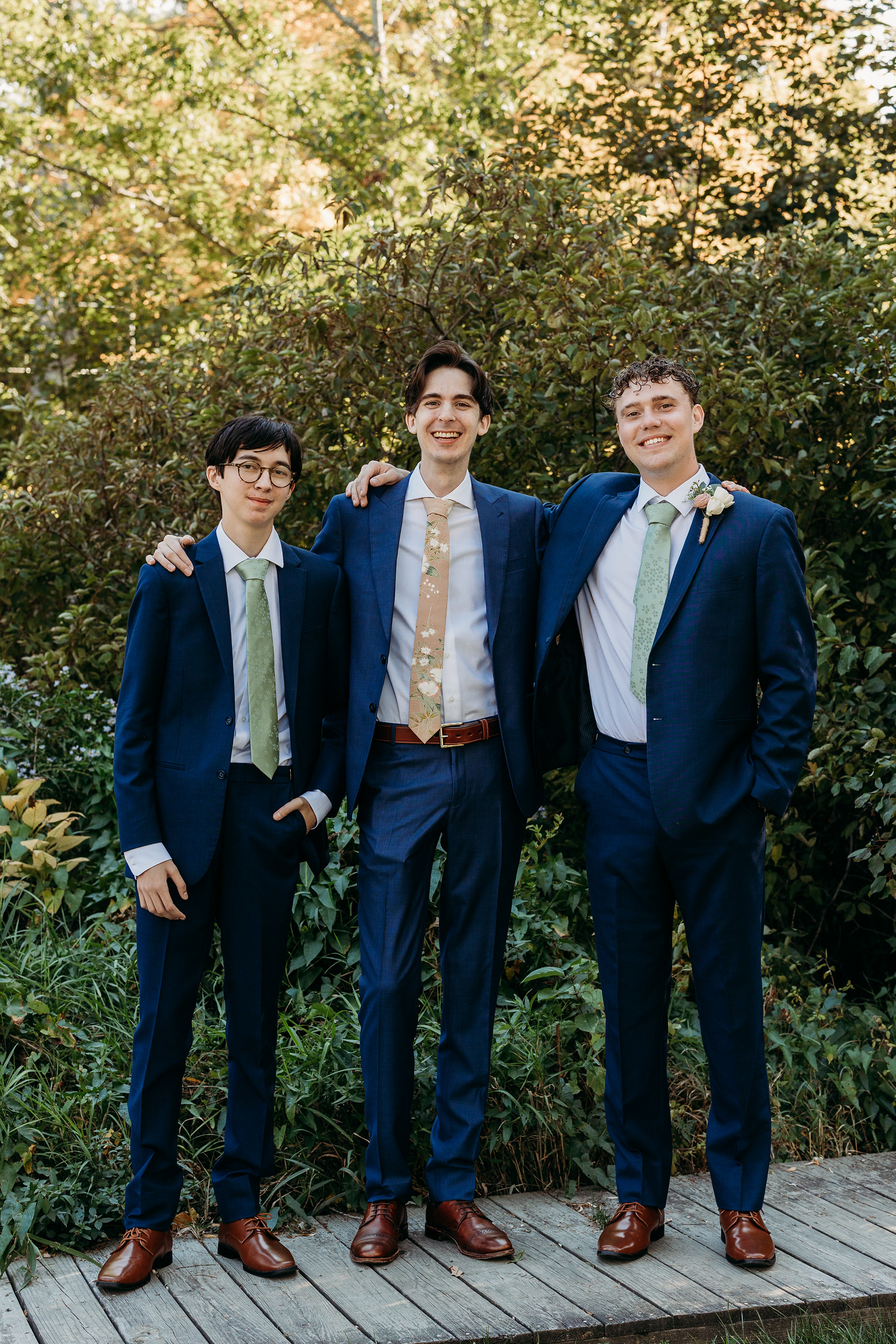 Groomsmen preparing at the Lakefield Cabin — laughter, ties, and the perfect start to a lakeside New Hampshire wedding day.