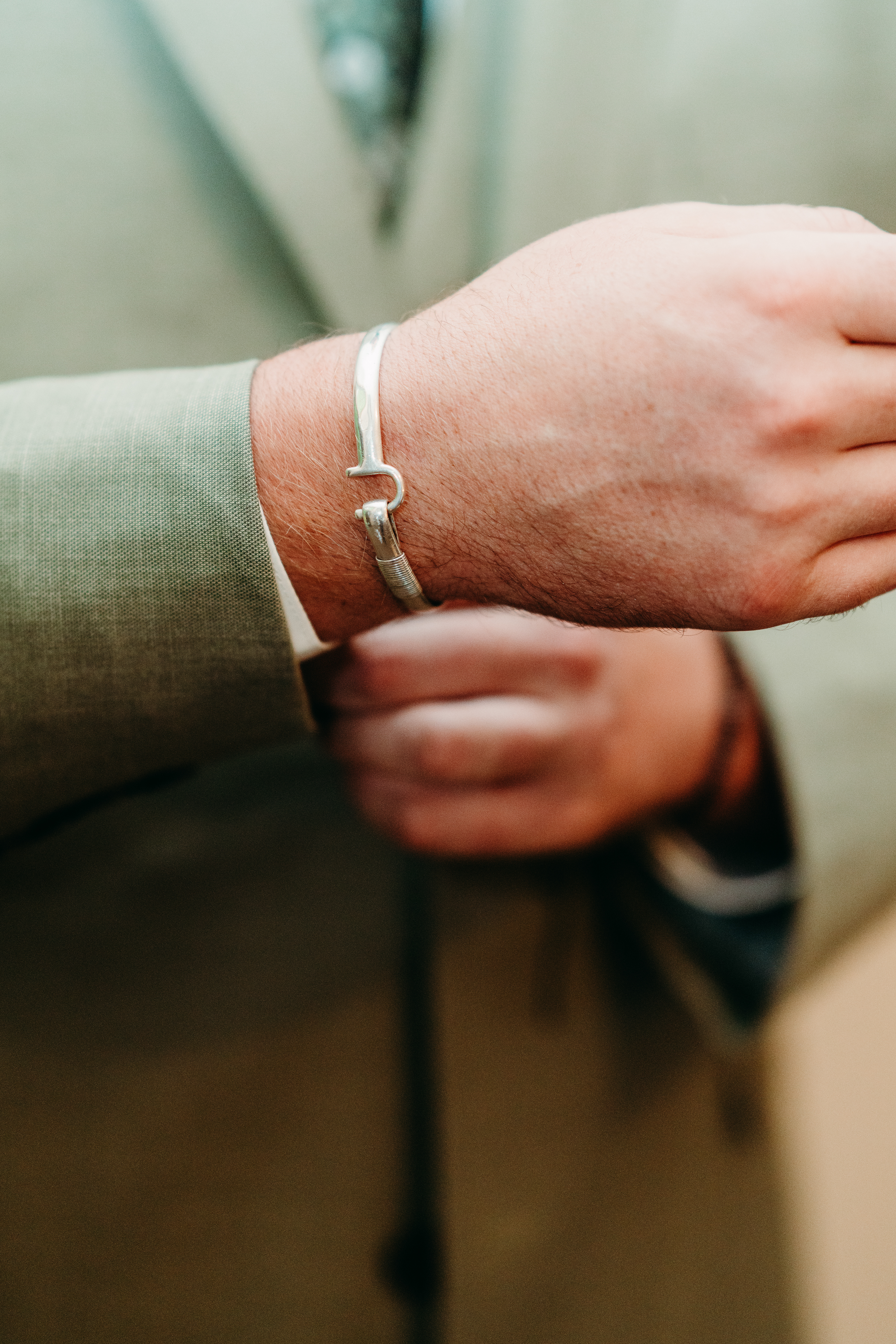 Hands adjusting the bracelet — subtle detail that completes the look for this elegant New Hampshire mountain wedding.