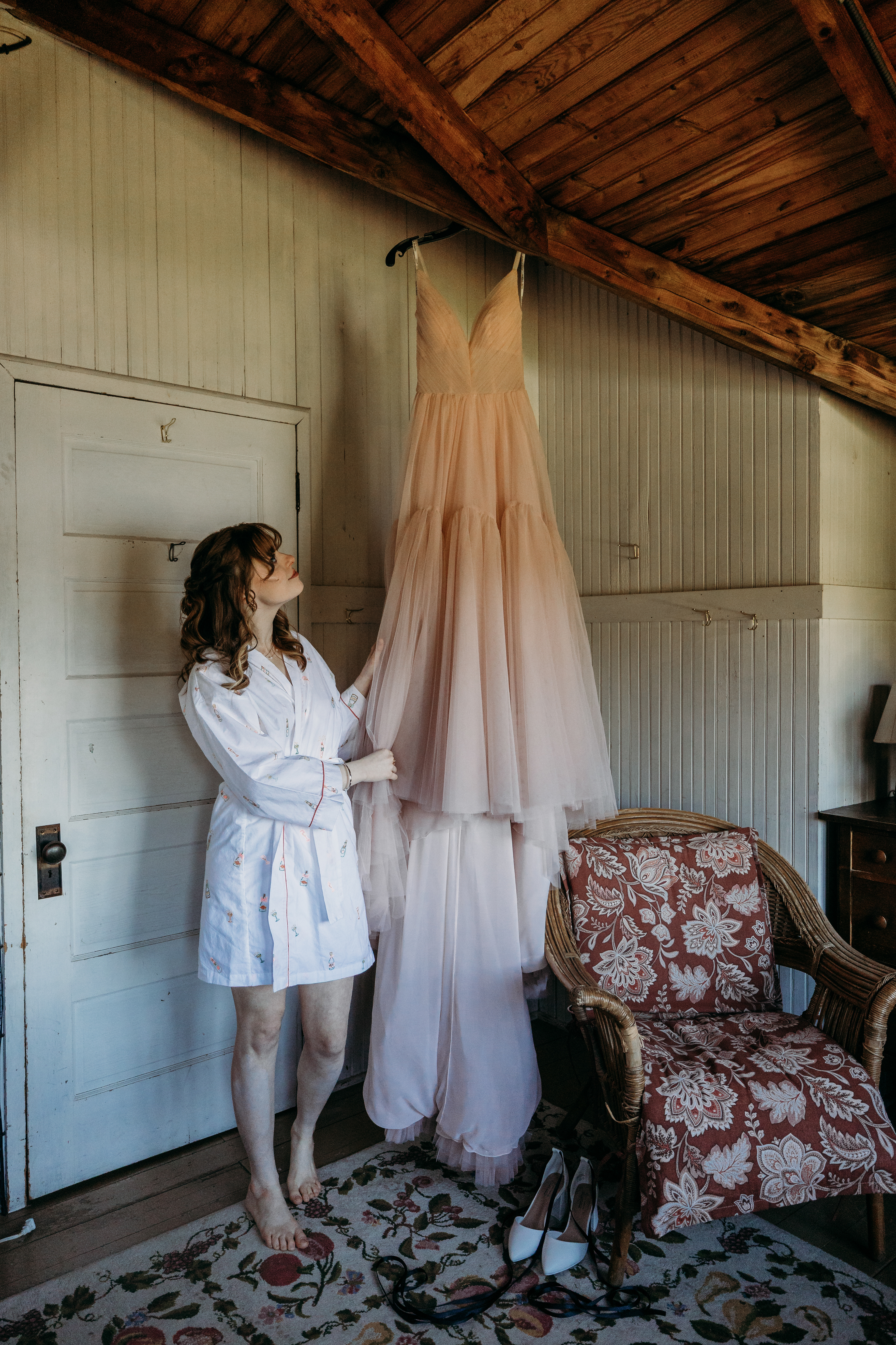 Her wedding dress catching the morning light — quiet, timeless beauty before the lakeside ceremony at this White Mountains wedding venue.