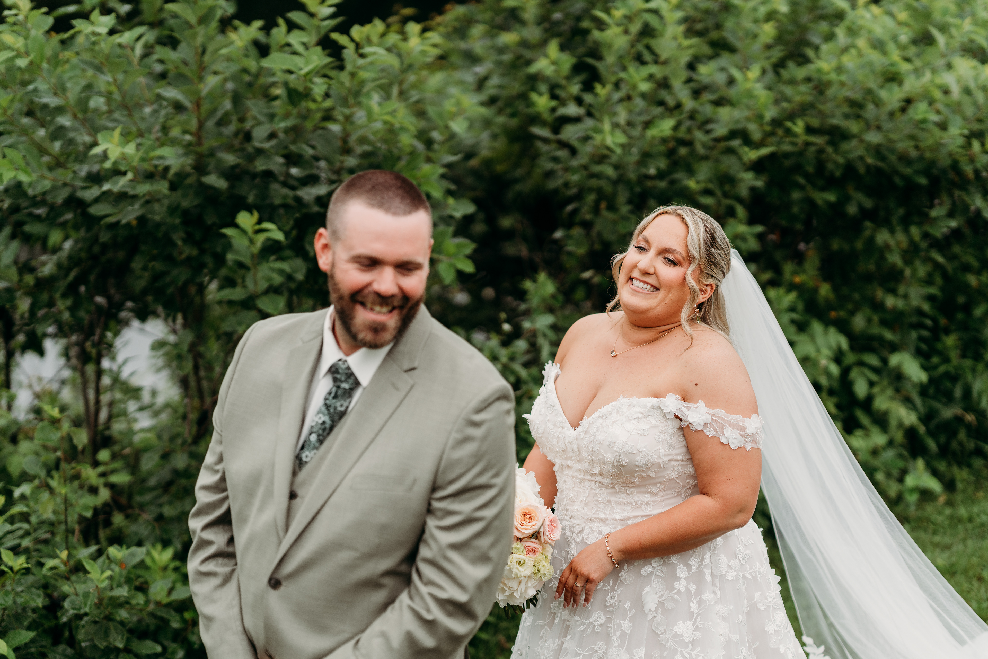 Bride walking toward her groom by the river, the fog rising behind them — an intimate New England wedding moment.
